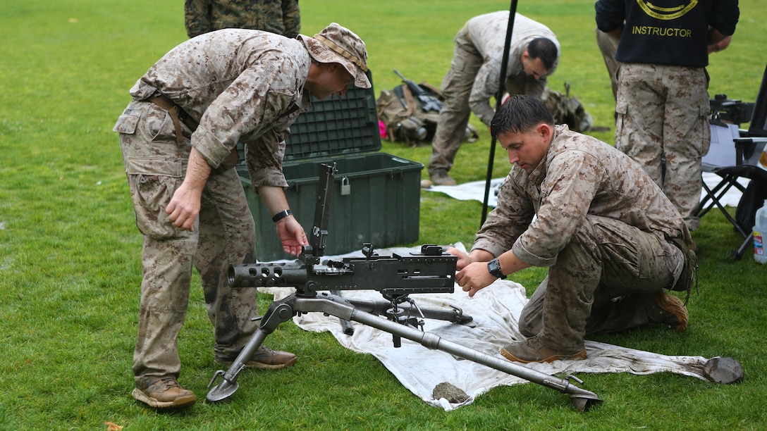 Staff Sgt. David Standridge, a reconnaissance Marine with 1st Reconnaissance Battalion, and Master Sgt. Vincent Marzi, the operations chief for 1st Force Reconnaissance Company, work as a team to assemble various weapon systems during station 5 of the 7th Annual Recon Challenge aboard Marine Corps Base Camp Pendleton, California, May 15, 2015. Competitors were tested on their knowledge as reconnaissance personnel.