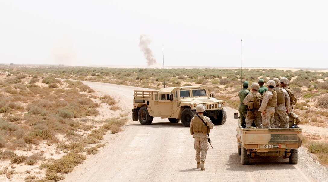 A truck full of Marines from 1st Battalion, 25th Marine Regiment and Moroccan soldiers wait for a nearby demolition range to be completed during exercise African Lion, May 15, 2015. The Moroccan and U.S. forces had been training on weapons systems all day and were on their way back to the Moroccan camp to spend time bonding and learning about one another. (U.S. Army photo by Staff Sgt. Jared Gehmann)