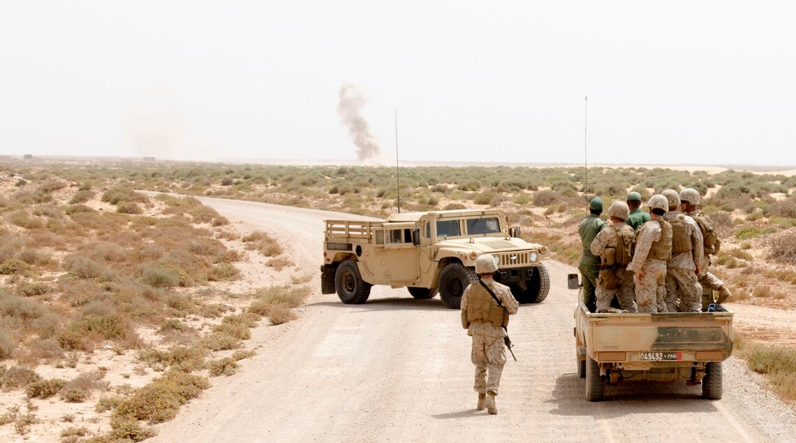 A truck full of Marines from 1st Battalion, 25th Marine Regiment and Moroccan soldiers wait for a nearby demolition range to be completed during exercise African Lion, May 15, 2015. The Moroccan and U.S. forces had been training on weapons systems all day and were on their way back to the Moroccan camp to spend time bonding and learning about one another. (U.S. Army photo by Staff Sgt. Jared Gehmann)
