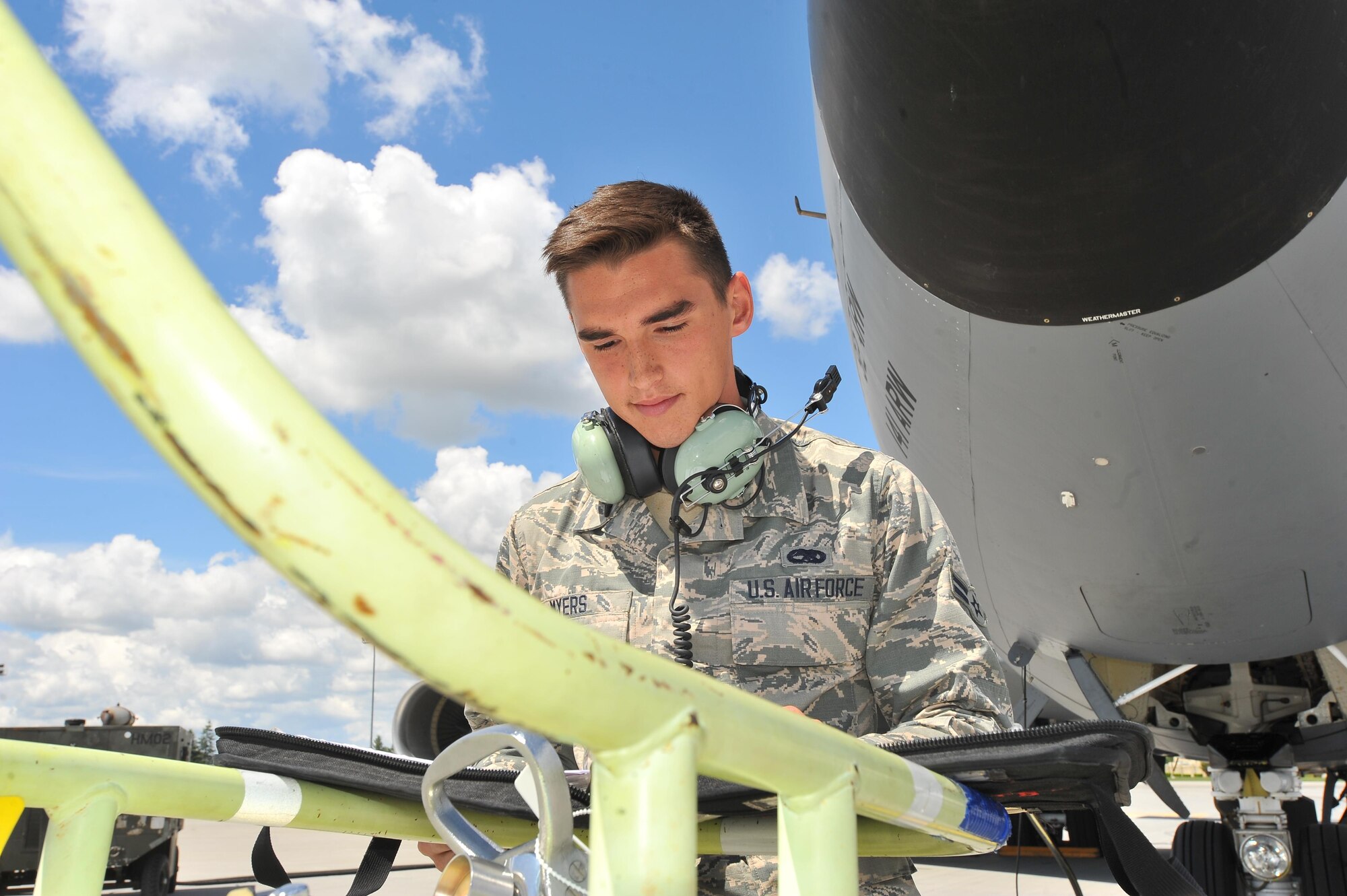 Airman 1st Class Jonah Myers, a 92nd Aircraft Maintenance Squadron crew chief, reads a maintenance checklist, May 27, 2015, at Fairchild Air Force Base, Wash. Myers rescued two females who were struggling to swim from the Spokane River May 22. (U.S. Air Force photo/Staff Sgt. Veronica Montes)