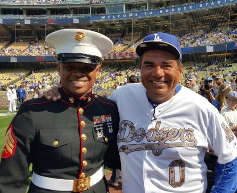 LOS ANGELES - U.S. Marine Corps Sgt. Vincent Webb, a recruiter with Recruiting Station Los Angeles, poses
with comedian George Lopez before the start of the Dodgers game, May 25. As
part of their appreciation to service members on Memorial Day, Marines were
invited on the field to throw the first pitch at Dodgers Stadium in Los
Angeles. Webb was one of five Marines recognized during the event. (Courtesy Photo/Released)

