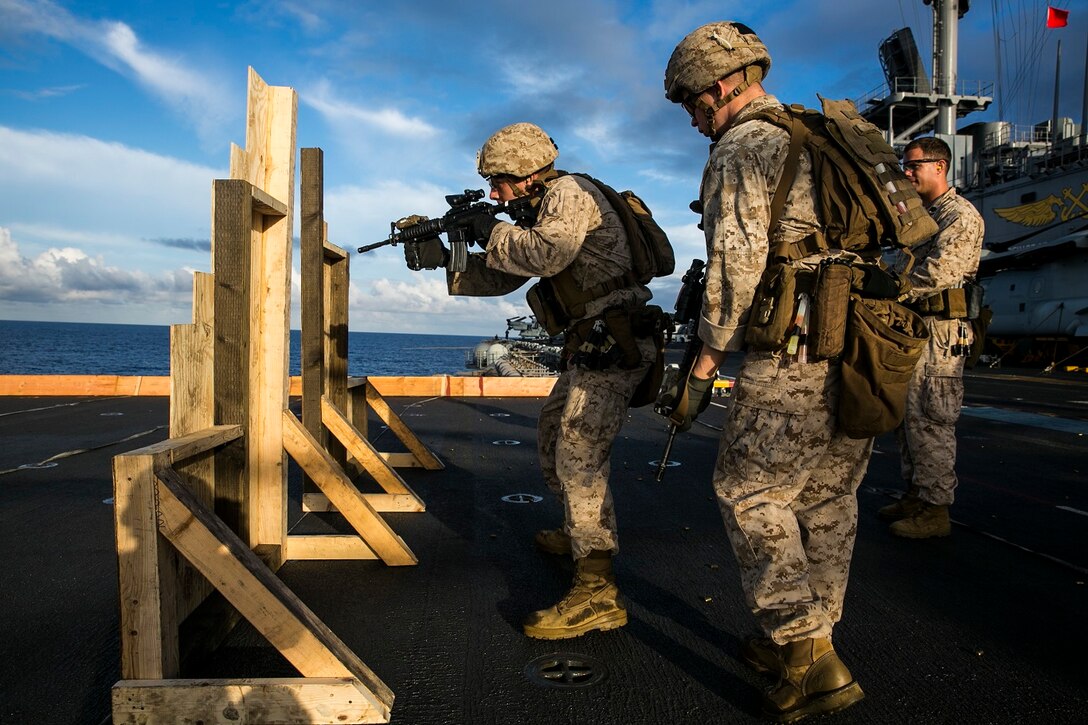 U.S. Marines with the 15th Marine Expeditionary Unit’s Maritime Raid Force practice room-entering procedures on the flight deck of the USS Essex (LHD 2) at sea in the Pacific Ocean, May 28, 2015. These Marines were executing drills that simulate entering a room and immediately seeing a target. (U.S. Marine Corps photo by Cpl. Anna Albrecht/ Released)