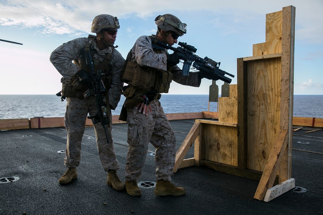U.S. Marines with the 15th Marine Expeditionary Unit’s Maritime Raid Force practice room-entering procedures on the flight deck of the USS Essex (LHD 2) at sea in the Pacific Ocean, May 28, 2015. These Marines were executing drills to efficiently enter a room with potential targets inside. (U.S. Marine Corps photo by Cpl. Anna Albrecht/ Released)