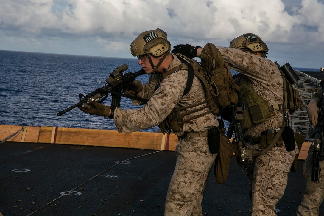 U.S. Marines with the 15th Marine Expeditionary Unit’s Maritime Raid Force practice marksmanship tactics on the flight deck of the USS Essex (LHD 2) at sea in the Pacific Ocean, May 28, 2015. This type of sustainment training is essential for the Marines to be able to swiftly and smoothly clear out target buildings. (U.S. Marine Corps photo by Cpl. Anna Albrecht/ Released)