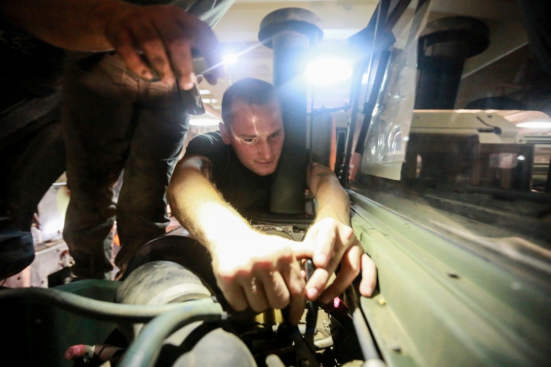 U.S. Marine Sgt. Carl Provost replaces a crankcase depression regulator valve on a Humvee aboard the USS Anchorage (LPD 23) at sea in the Pacific Ocean, May 25, 2015. Provost is a motor transportation maintenance chief with the Command Element, 15th Marine Expeditionary Unit. The Marines of the 15th MEU constantly perform maintenance on their equipment to maintain combat readiness. (U.S. Marine Corps photo by Cpl. Steve H. Lopez/Released)