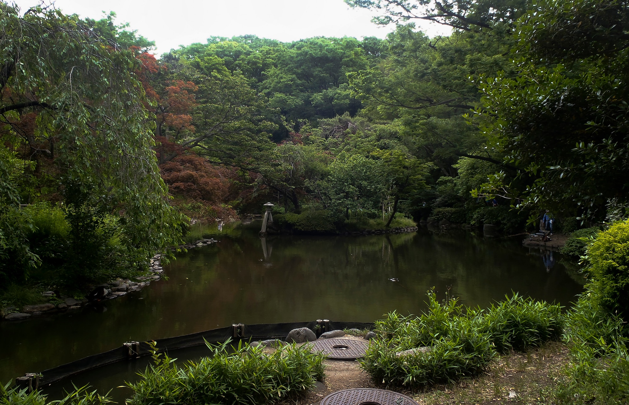 A man fishes in a pond May 25, 2015, at Arisugawa Park, Minato, Japan. The park covers an area of 67,131 square meters. (U.S. Air Force photo by Senior Airman David Owsianka/Released)