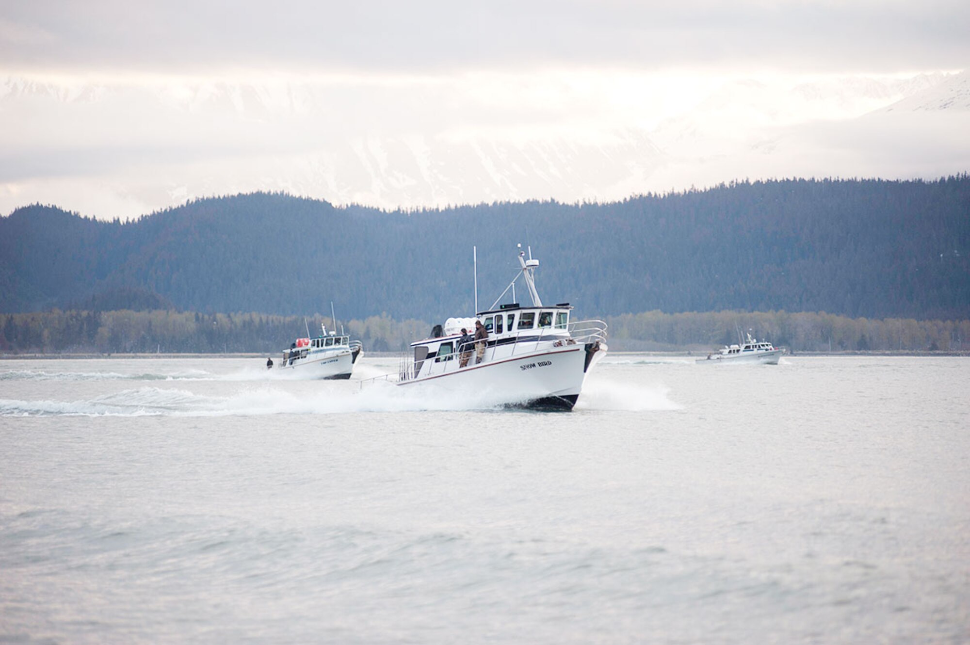 Fishing vessels pass by mountains and views of glaciers during the Armed Services YMCA Combat Fishing Tournament near Seward May 20. This is the ninth year area charter fishermen have donated time and tackle for service members. “It’s not just a fishing trip,” said Steve Zernia, captain of the Pursuit. “There’s a lot of stuff to see on the way out to and from fishing; mountains, glaciers, sea lions, porpoises and occasionally whales, stuff like that.” (U.S. Air Force photo/Tech. Sgt. Robert Barnett)