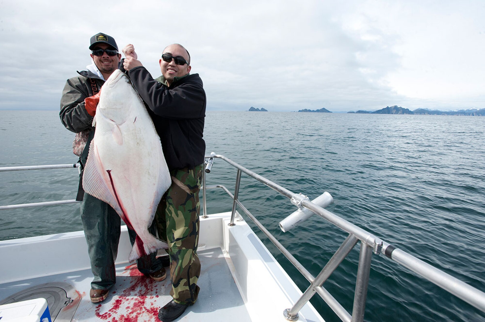 Rendinald Tan (right) and a crew member of the fishing boat the Pursuit show off Tan’s halibut catch during the ninth annual ASYMCA Combat Fishing Tournament at Seward May 20. “It was awesome – a once-in-a-lifetime experience,” said Tan, a unit program manager with the 962nd Aircraft Maintenance Unit. (U.S. Air Force photo/Tech. Sgt. Robert Barnett)