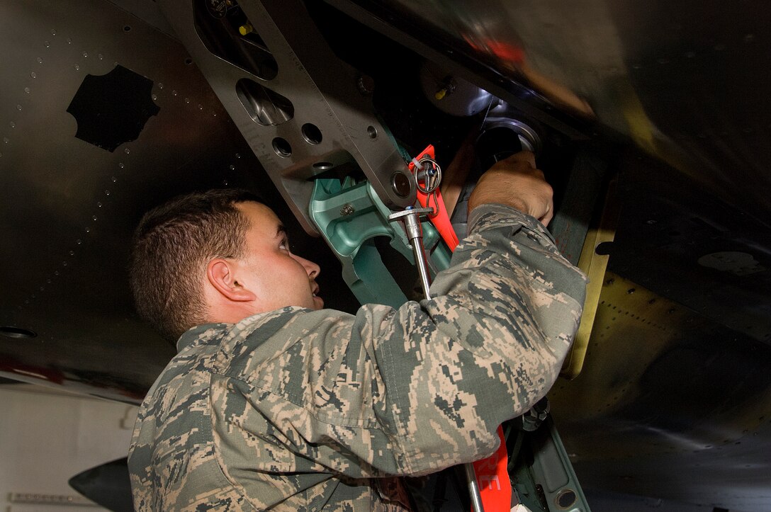 Airman Corey Henry, 362nd Training Squadron student, performs maintenance on the arresting hook damper on an F-15 Eagle air superiority fighter May 28, 2015, at Sheppard Air Force Base, Texas. Students learn to properly inspect, troubleshoot and service the arresting gear that will prepare them for operational environments and ready crew chiefs for real-world conflicts. (U.S. Air Force photo by Danny Webb/Released)
