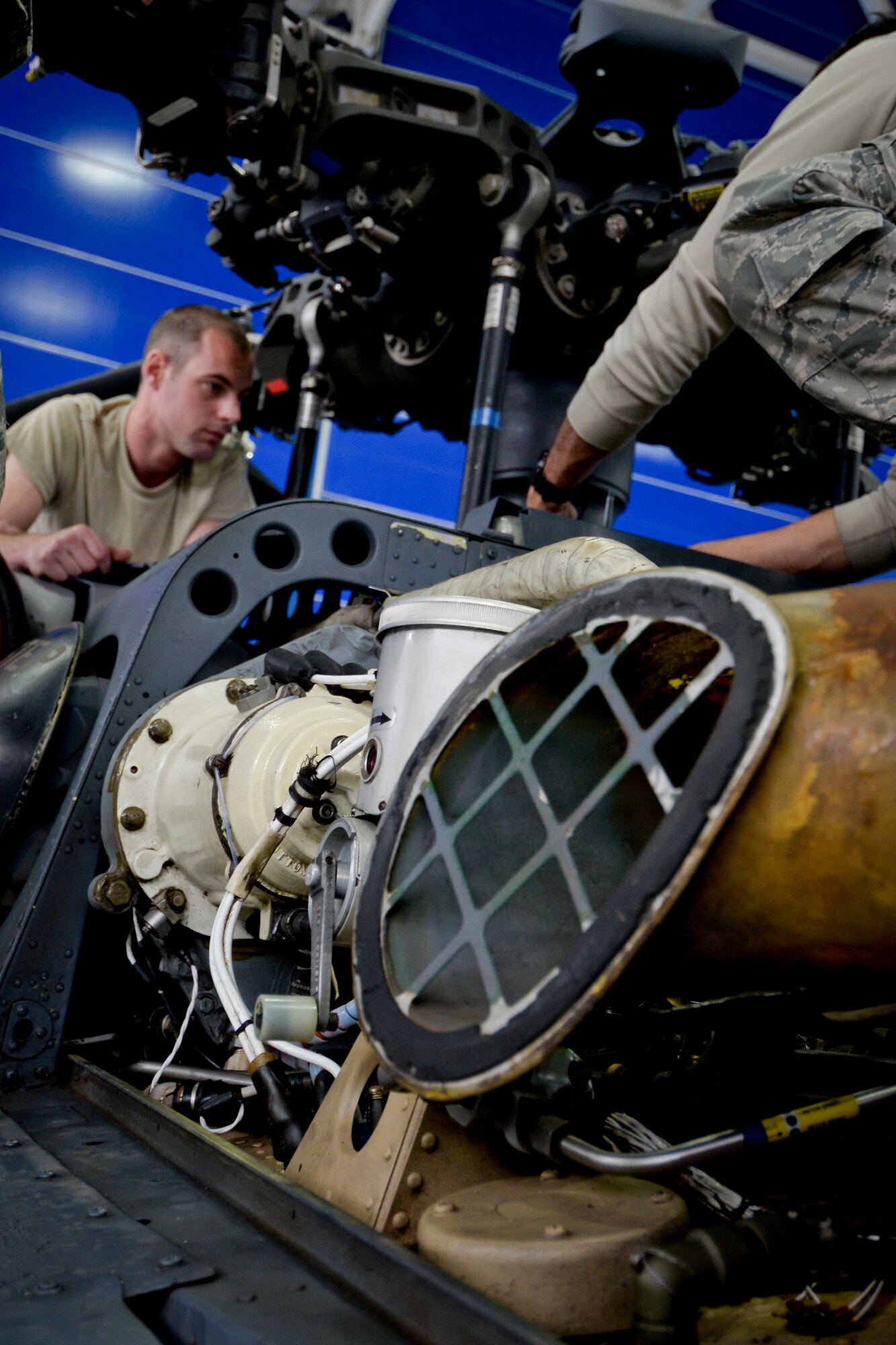 California Air National Guardsman Senior Airman Jeffery M. Thomas, a crew chief with the 129th Maintenance Group, works on the main rotor head of an HH-60G Pave Hawk rescue helicopter, Moffett Federal Airfield, Calif., May 2, 2015. This maintenance is being conducted as part of a 50 hour flight inspection. (U.S. Air National Guard photo Staff Sgt. Kim E. Ramirez/Released)