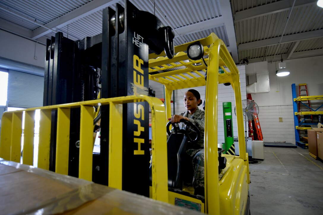 California Air National Guardsman Staff Sgt. Cristina Eversole, a transportation technician with the 129th Rescue Wing, moves cargo to the warehouse floor, Moffett Federal Airfield, Calif., May 2, 2015. Eversole’s daily responsibilities as part of the Logistical Readiness Squadron include the receiving and shipping of all assets to and from the unit. (U.S. Air National Guard photo Staff Sgt. Kim E. Ramirez/Released)