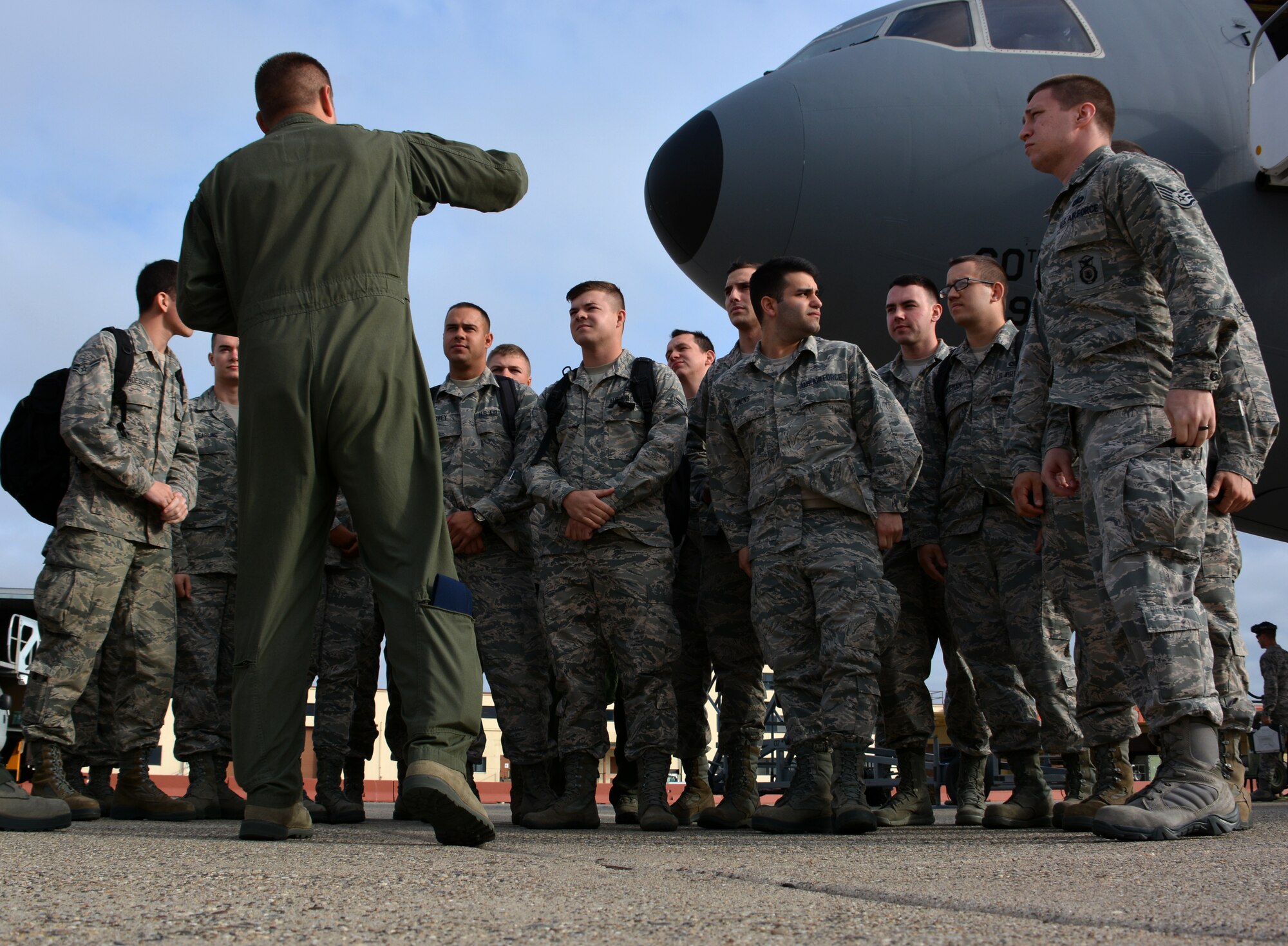 Senior Master Sgt. Shane Hickman, 9th Air Refueling Squadron superintendent, speaks to more than a dozen first-term Airmen May 21, 2015, prior to an incentive flight onboard the KC-10 Extender at Travis Air Force Base, California. The flight is part of an initiative to expose junior Airmen to the operational mission at Travis. (U.S. Air Force photo by Senior Airman Charles Rivezzo)