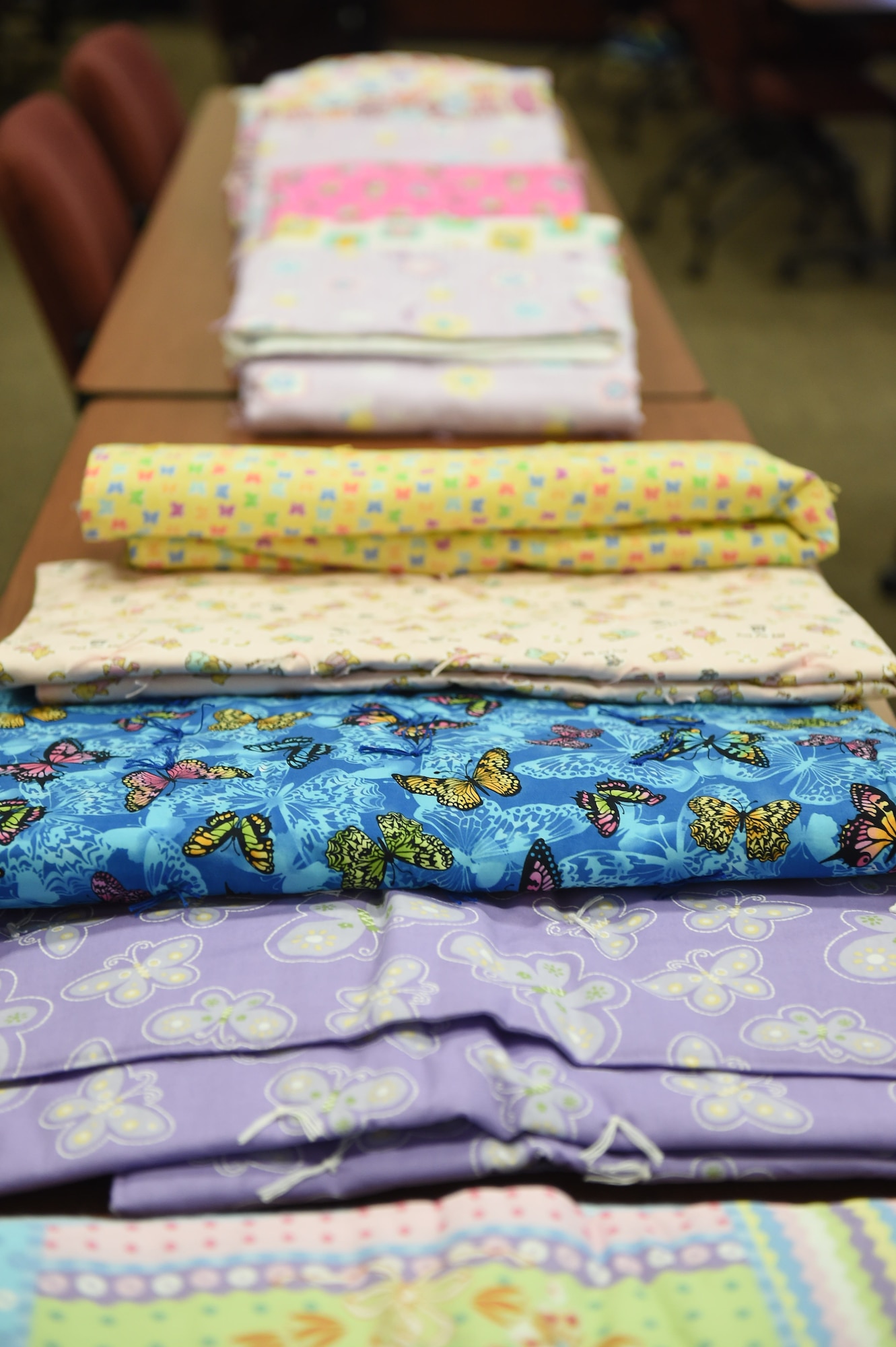 Blankets for expecting and new parents to take home are on display during Bundles for Babies May 27, 2015, on Buckley Air Force Base, Colo. The class is offered to expecting and new parents and covers a range of topics such as car seat safety, nutrition, fitness, mental health, dividing childcare and chores, navigating common disagreements between spouses, and a family budgeting session. At the end of the class, each family gets to take home a “bundle” that contains bibs, onesies, pajamas, burp towels, bath towels, crib sheets and mittens sponsored by the Air Force Aid Society. (U.S Air Force photo by Airman 1st Class Samantha Meadors/Released)