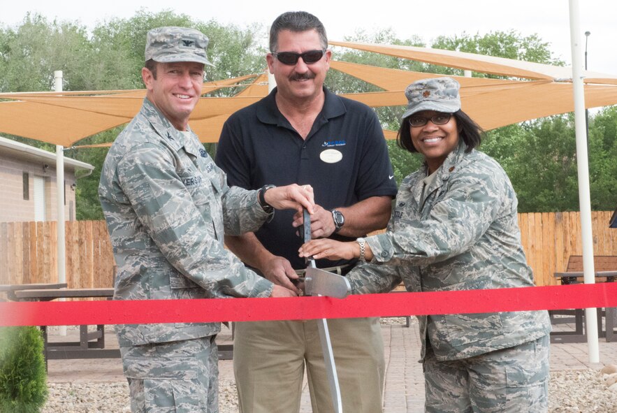 Col. David Iverson, 366th Fighter Wing commander, officially opened the Gunfighter Greens Golf Course with John Bitrick, 366th Force Support Squadron Bowling Center manager and Maj. Nekitha Little, 366th FSS commander May 27, 2015, behind the Bowling Center at Mountain Home Air Force Base, Idaho. The course is base-themed featuring the front gate, water tower, hanger 211 and the aircraft control tower. (U.S. Air Force photo by Senior Airman Malissa Lott/RELEASED)
