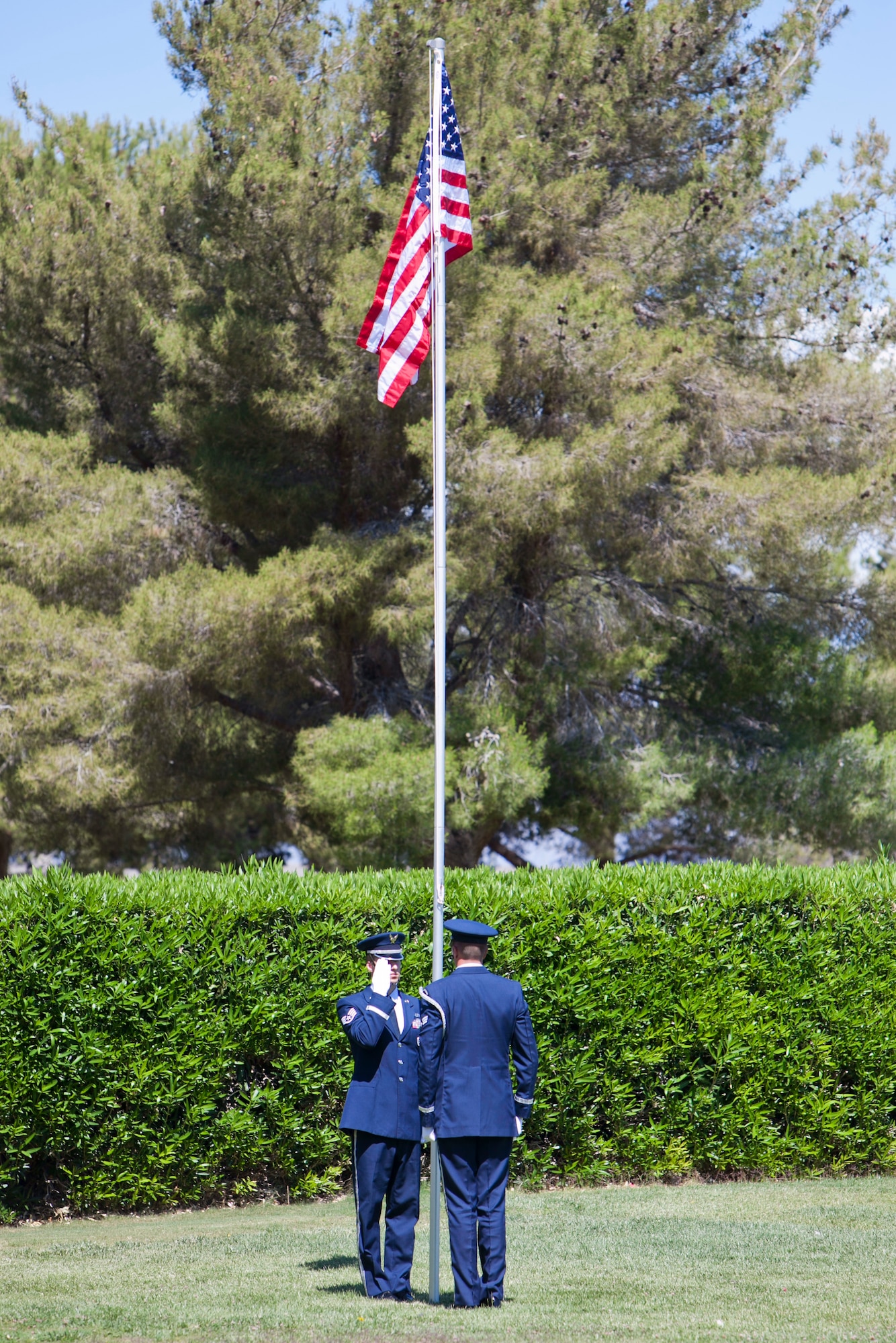 Members of the Nellis Air Force Base Honor Guard raise
the American flag to full-staff during a Memorial Day
ceremony at the Davis Funeral Homes and Memorial
Park in Las Vegas, May 25. The proper protocol for
flying the American Flag on Memorial Day slightly
differs from other occasions; on Memorial Day, flags
are flown at half-staff from sunrise until noon only,
and then raised quickly to full-staff. (U.S. Air Force photo by Lorenz Crespo)  