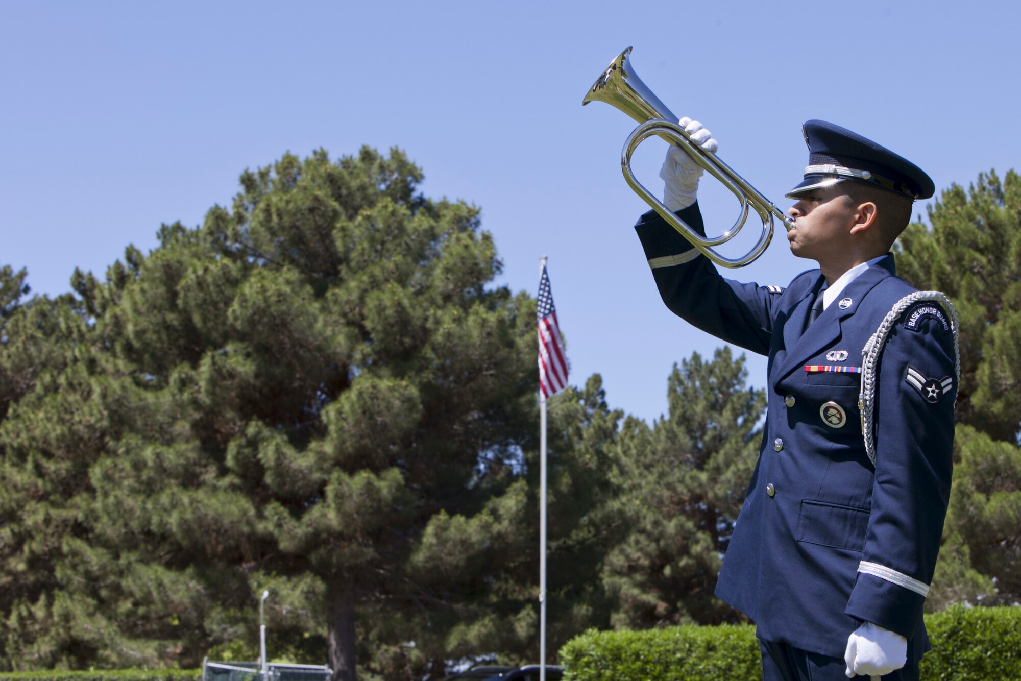 Airman1st Class Esteban Castillo, Nellis Air Force Base Honor Guard
member, plays taps during a Memorial Day ceremony at the Davis
Funeral Homes and Memorial Park in Las Vegas, May 25. The funeral
home, Veterans of Foreign Wars post and the local community paid
special tribute to honor those who sacrificed their lives in foreign wars
during the Memorial Day weekend. (U.S. Air Force photo by Lorenz Crespo)  