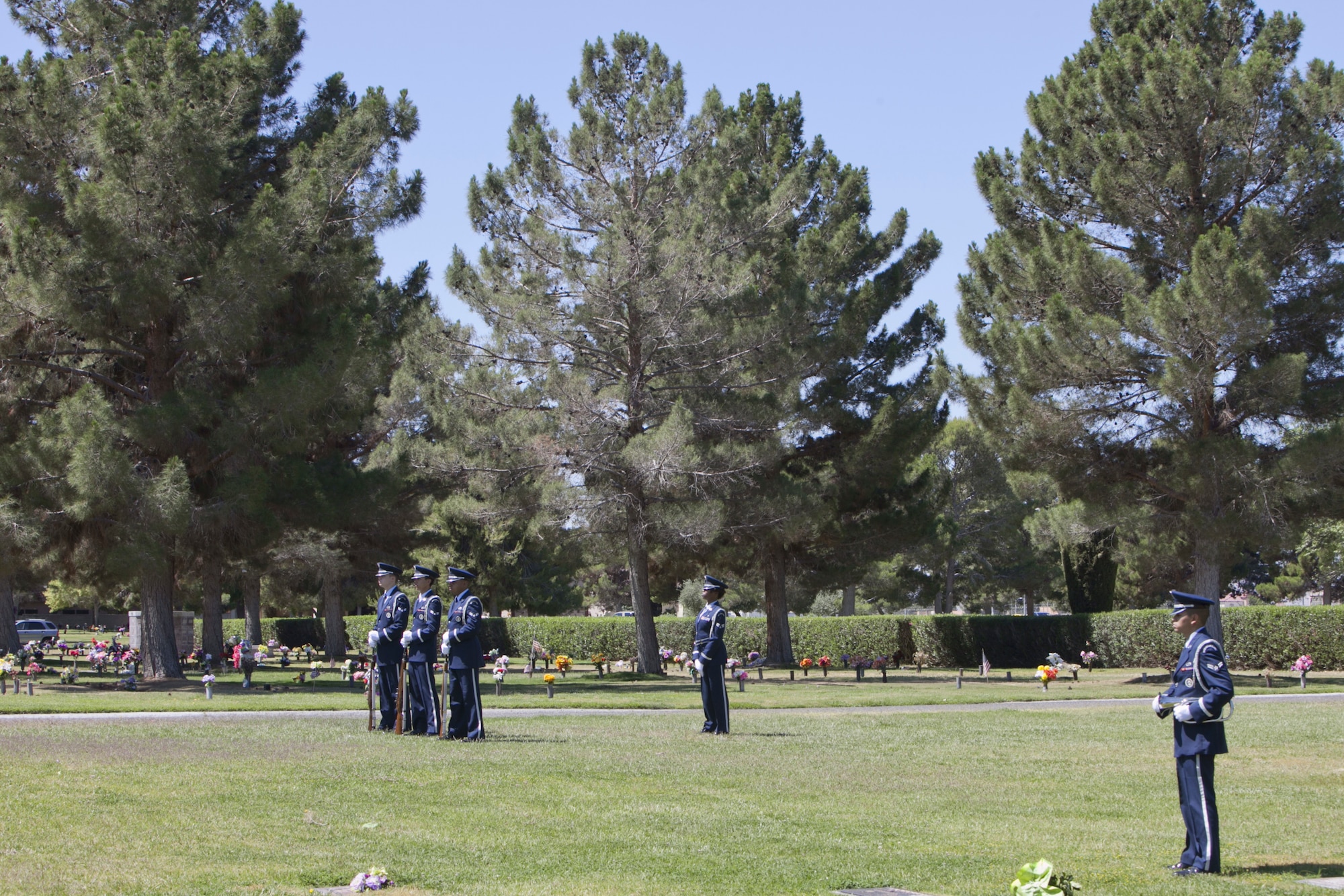 The Nellis Air Force Base Honor Guard waits to perform a gun salute and taps during a Memorial Day ceremony at the Davis Funeral Homes and Memorial Park in Las Vegas, May 25. A 21-gun salute is a customary gun salute that is performed by the firing of cannons or firearms as a military honor. (U.S. Air Force photo by Lorenz Crespo)  