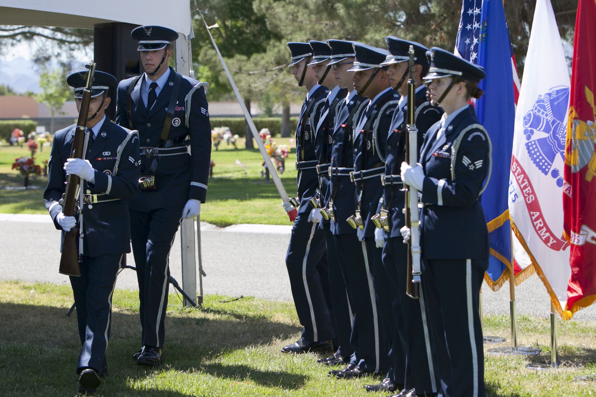 Members of the Nellis Air Force Base Honor Guard exit the Davis Funeral Homes
and Memorial Park ceremonial site after the presentation of colors during a
Memorial Day ceremony in Las Vegas, May 25. The American, Nevada State,
and all Department of Defense military flags waved as flowers graced the
graves of deceased veterans. (U.S. Air Force photo by Lorenz Crespo)  