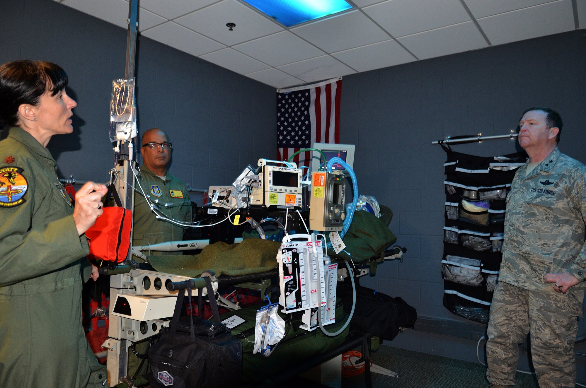 Maj. Trish Hayden and Tech. Sgt. Raul Jimenez, 920th Rescue Wing critical care air transport team, explain the function of their training lab to Maj. Gen. Richard Scobee, 10th Air Force commander. The lab is a simulated military aircraft where they could practice their life-saving skills in the confines of an ‘aircraft’, complete with dim lights, the roar of an airplane engine and limited work space.  Scobee visited the Rescue Wing to familiarize himself with the missions and heroes of his rescue and special operations components. (Air Force photo/1st Lt. Leslie Forshaw)