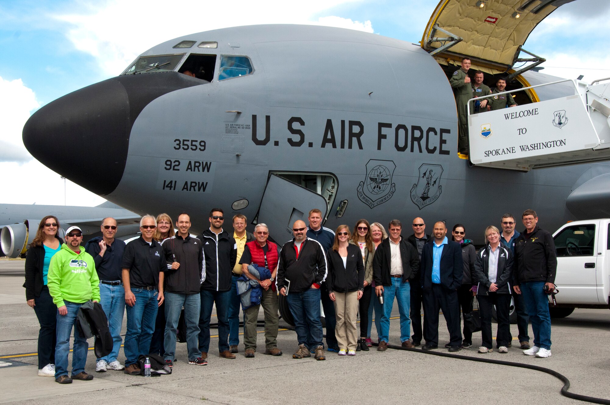 Twenty one members of the West Plains Chamber of Commerce pose for a post-flight photo after an orientation flight May 26, 2015, at Fairchild Air Force Base, Wash that took them over Washington, Oregon and Idaho while viewing the refueling of a C-17 Globemaster III cargo aircraft from Joint Base Lewis-McChord, Wash., and F-15 Eagles from the 173rd Fighter Wing stationed at Klamath Falls, Ore. Providing opportunities such as orientation flights to local civic and business leaders is one of the ways the Air Force builds public trust and support and strong relationships with the local community. (U.S. Air Force Photo/Capt. David A. Liapis)