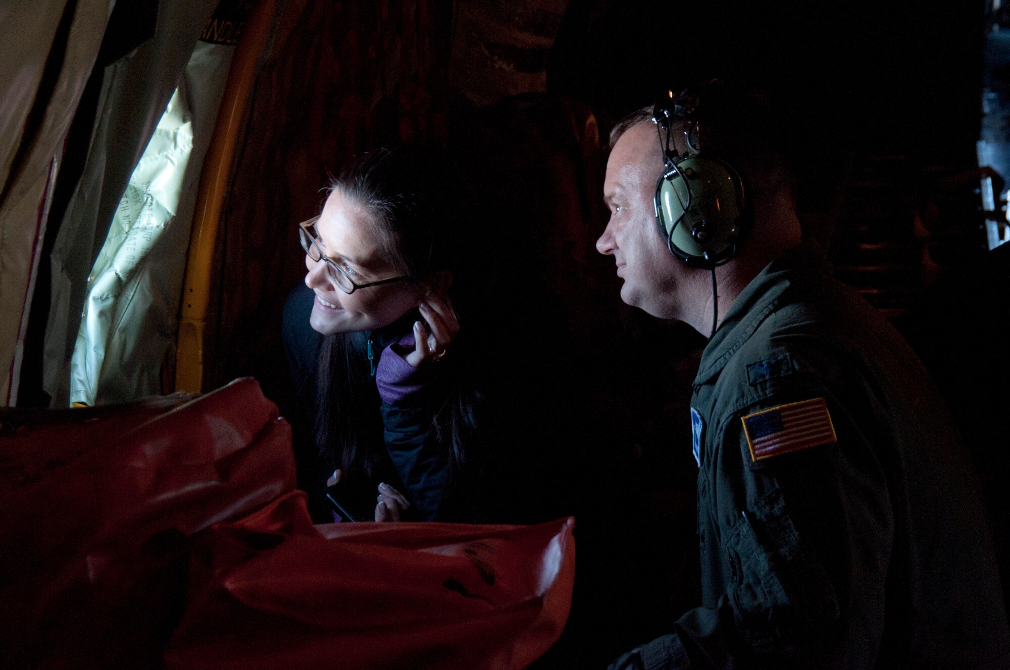 Meg Miller, Northern Quest Casino representative for the West Plains Chamber of Commerce, and Col. Brian McDaniel, 92nd Air Refueling Wing commander, watch as F-15 Eagles from the 173rd Fighter Wing stationed at Klamath Falls, Ore. fly in formation off the wingtip of a KC-135 Stratotanker air refueling aircraft from the 92nd Air Refueling Wing, Fairchild Air Force Base, Wash., May 26, 2015. The F-15’s fly in formation alongside the tanker KC-135 while awaiting their turn to be refueled, an operation 21 members of the West Plains Chamber of Commerce were able to witness during an orientation flight. (U.S. Air Force Photo/Capt. David A. Liapis)