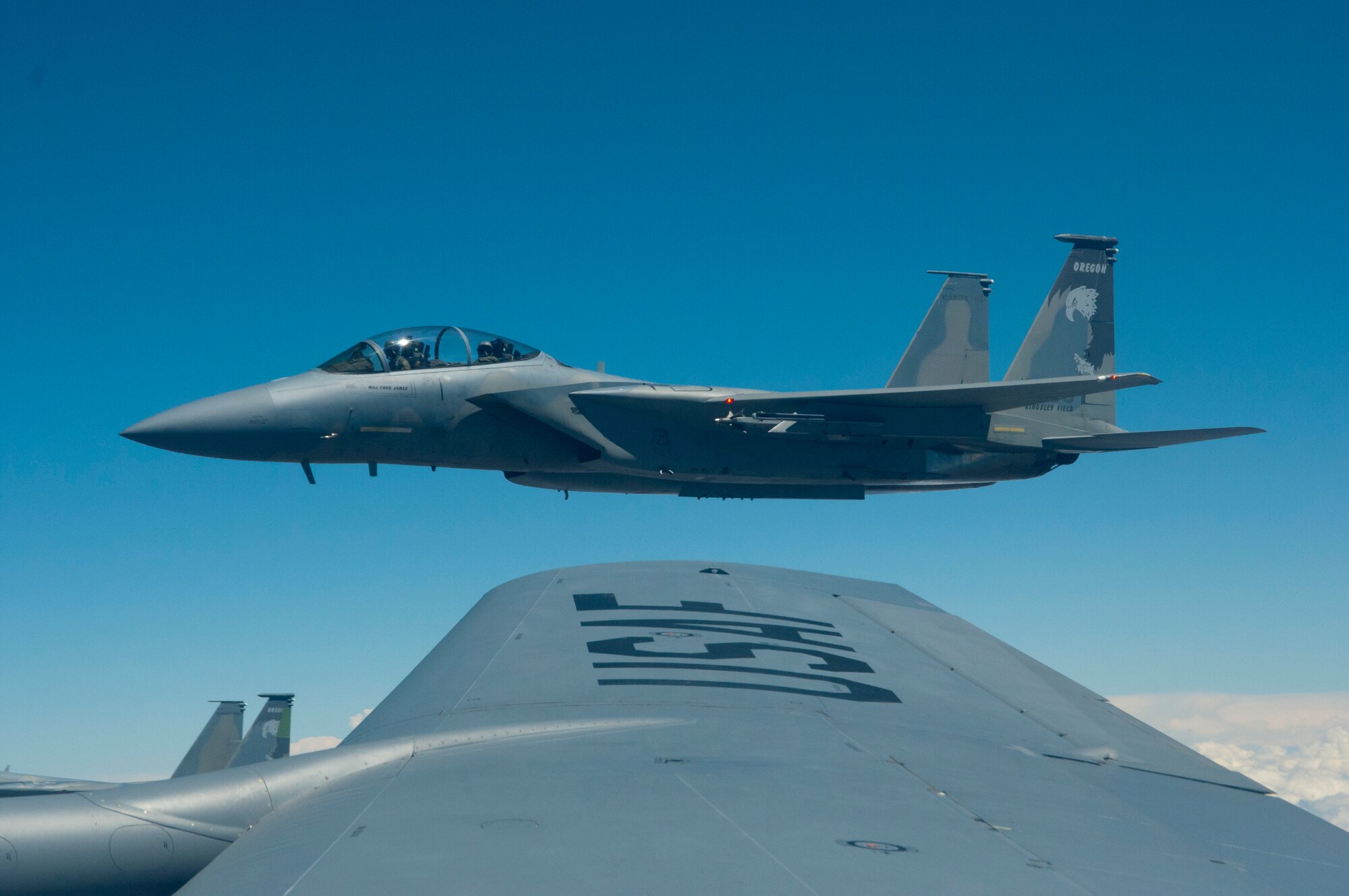 An F-15 Eagle fighter jet from the 173rd Fighter Wing stationed at Klamath Falls, Ore., awaits its turn for air refueling from a KC-135 Stratotanker from Fairchild Air Force Base, Wash., May 26, 2015. The refueling of the fighter jets was a planned part of an orientation flight on the KC-135 for members of the West Plains Chamber of Commerce, enabling the 21 members to see Fairchild’s primary mission in action. (U.S. Air Force Photo/Capt. David A. Liapis)