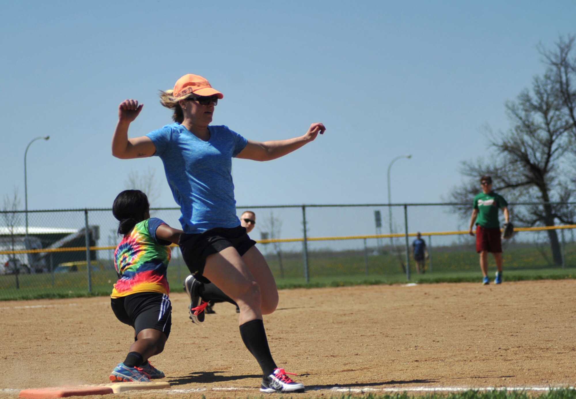 Staff Sgt. Kadra Miller, 5th Force Support Squadron force management supervisor from Minot Air Force Base, runs to first base during the Minot AFB vs. Grand Forks AFB softball tournament all-female game at Roosevelt Park in Devils Lake, N.D., May 21, 2015. Minot AFB won the game, 22-2. The tournament was the first time the two bases came together on the field of play for a morale boosting event.  (U.S. Air Force photo by Airman 1st Class Bonnie Grantham/Released)