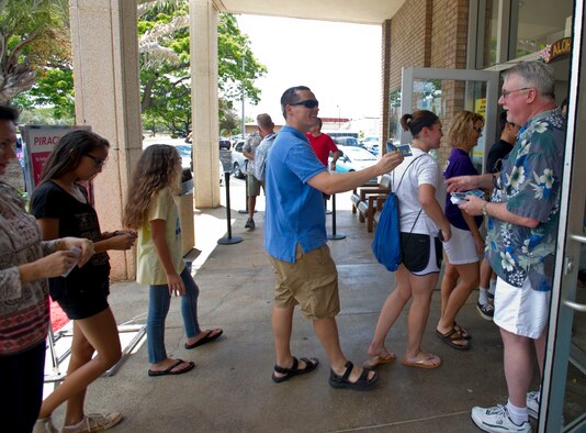 Military members and their families attend the premier of the movie “Aloha” at the Memorial Base Theater on Joint Base Pearl Harbor-Hickam, Hawaii, May 17, 2015. The Cameron Crowe-directed movie was filmed on JBPHH in 2013. It features a host of well-known Hollywood stars portraying what life for Airmen and their families living and working on JBPHH is like. (U.S. Air Force photo by Tech. Sgt. Terri Paden/RELEASED)