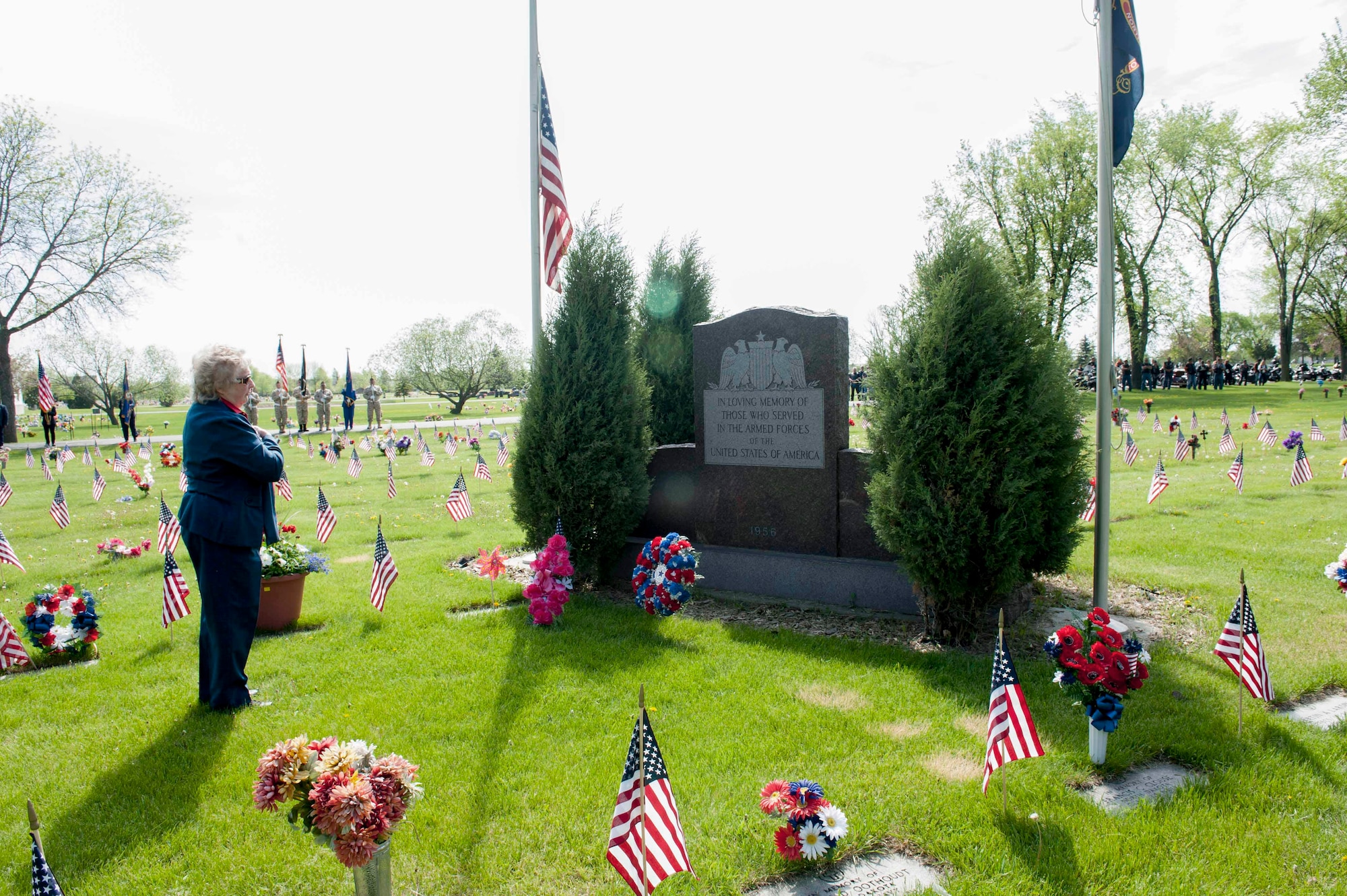 A Minot community member places a remembrance wreath at a monument during a Memorial Day event at Rosehill Cemetery in Minot, N.D., May 25, 2015. During the event, friends and families of those who have passed while serving in the armed forces placed flags on the graves of their loved ones. (U.S. Air Force photo/Airman 1st Class Sahara L. Fales)