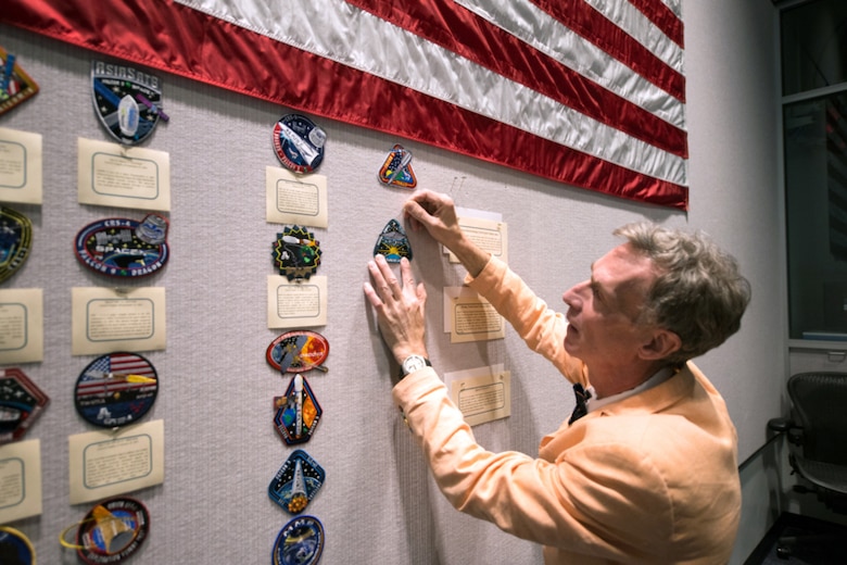 Bill Nye, Planetary Society CEO, pins a LightSail mission patch on the wall inside the Morrell Operations Center, May 21, 2015, at Cape Canaveral Air Force Station, Fla. Team Patrick-Cape hosted Bill Nye the Science Guy and the Planetary Society team for a tour of CCAFS and met with several Airmen. (Courtesy photo/Navid Baraty/Planetary Society) (For limited release) 