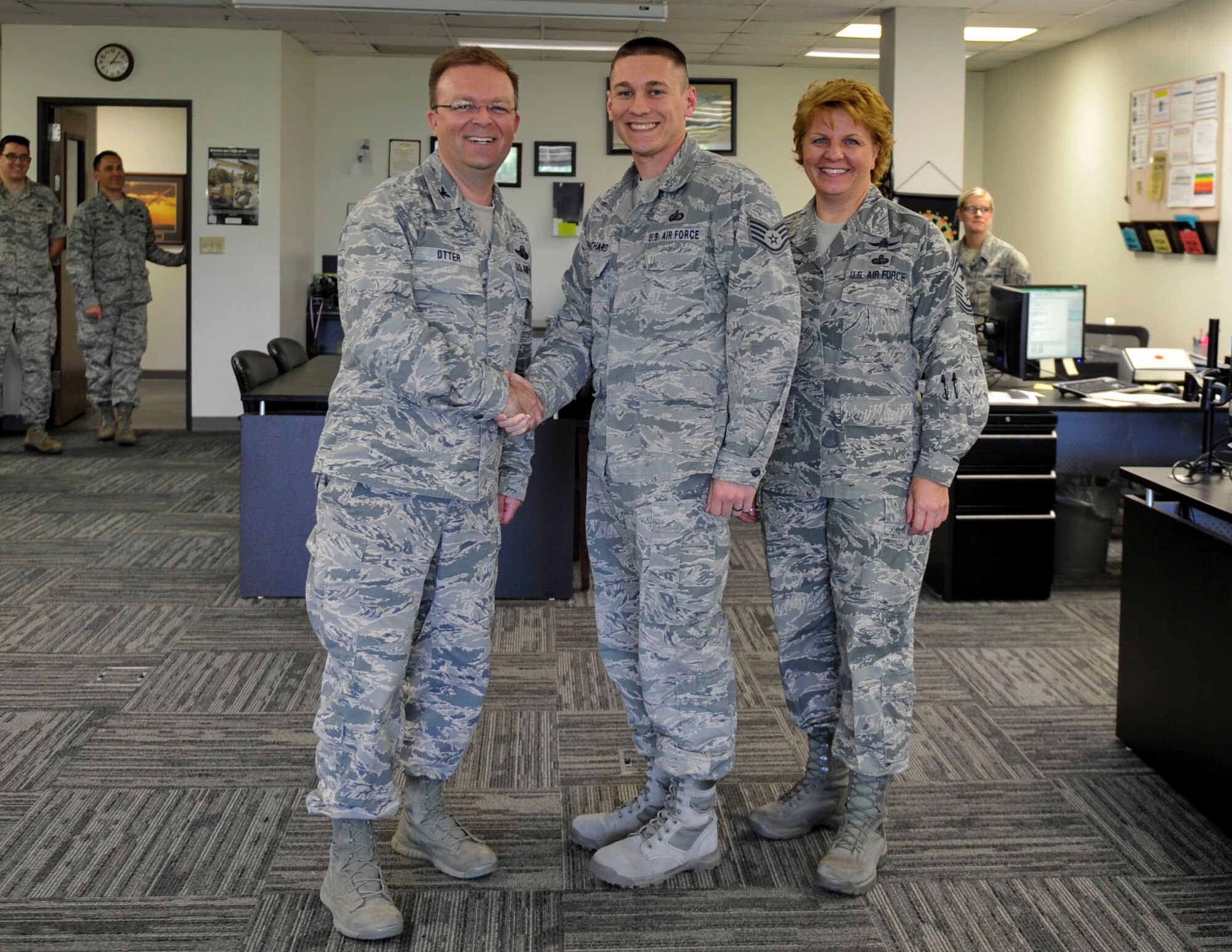 Col. Bill Otter, 19th Airlift Wing vice commander, along with Chief Master Sgt. Rhonda Buening, 19th Airlift Wing command chief, congratulate Staff Sgt. Gary Richard III, a 19th Comptroller Squadron noncommissioned officer in charge budget analyst, for his selection as Combat Airlifter of the Week May 26, 2015, at Little Rock Air Force Base, Ark. Initiated peer to peer training of three Wings in Air Combat Command, Air Mobility Command, and Air Force Global Strike Command on implementation of new Defense Enterprise Accounting Management System which allowed for the transition of over $425 million. (U.S. Air Force photo by Senior Airman Stephanie Serrano)
