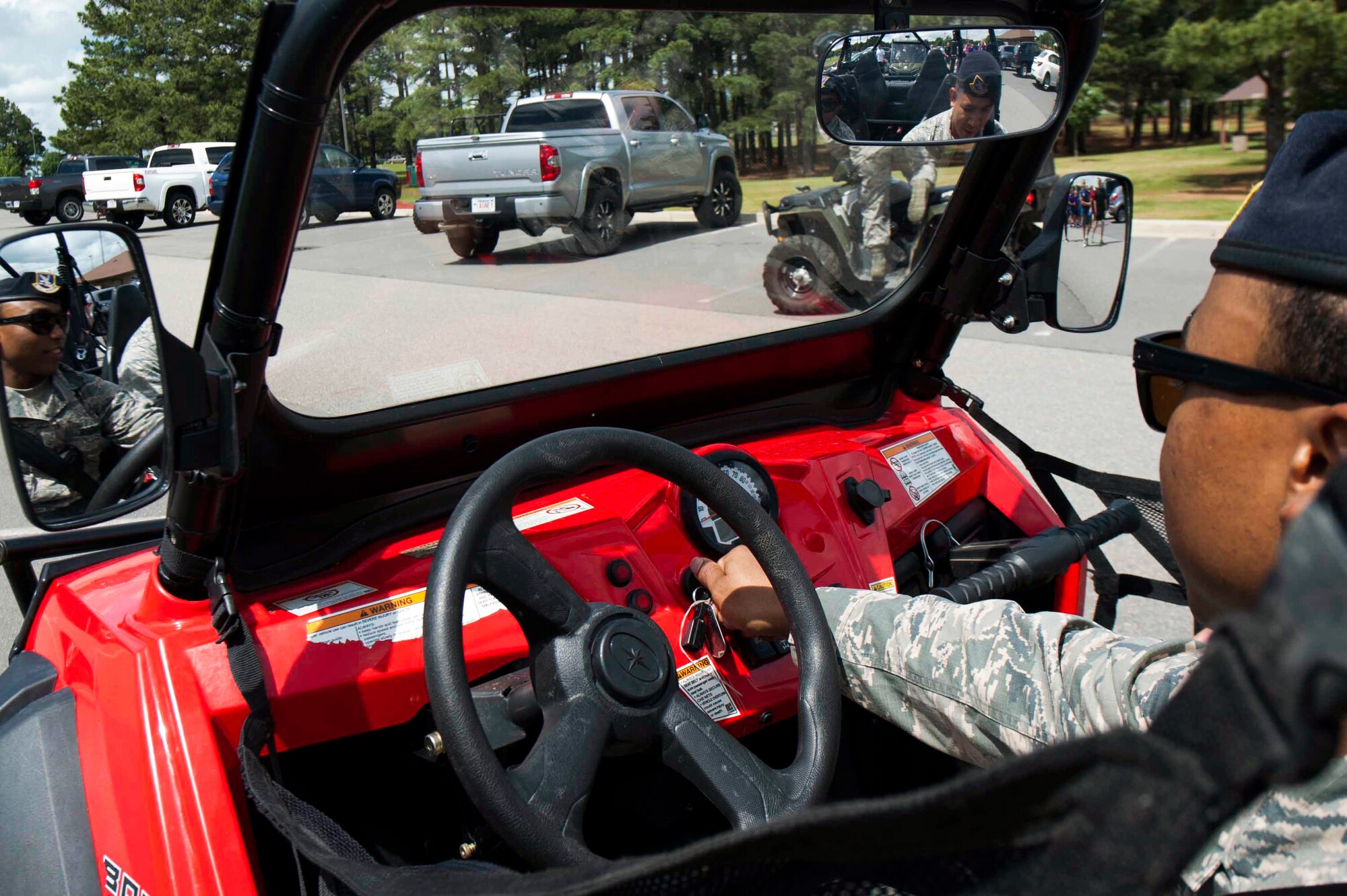 Senior Airman Aaron Rivers, a 19th Security Forces Squadron patrolman, drives an all-terrain vehicle as an escort for the 5K Blue Line Run in honor of Police Week May 11, 2015, at Little Rock Air Force Base, Ark. The week included events to commemorate fallen military and civilian law enforcement officers and provided morale-building activities for participants to enjoy. (U.S. Air Force photo by Senior Airman Kaylee Clark)