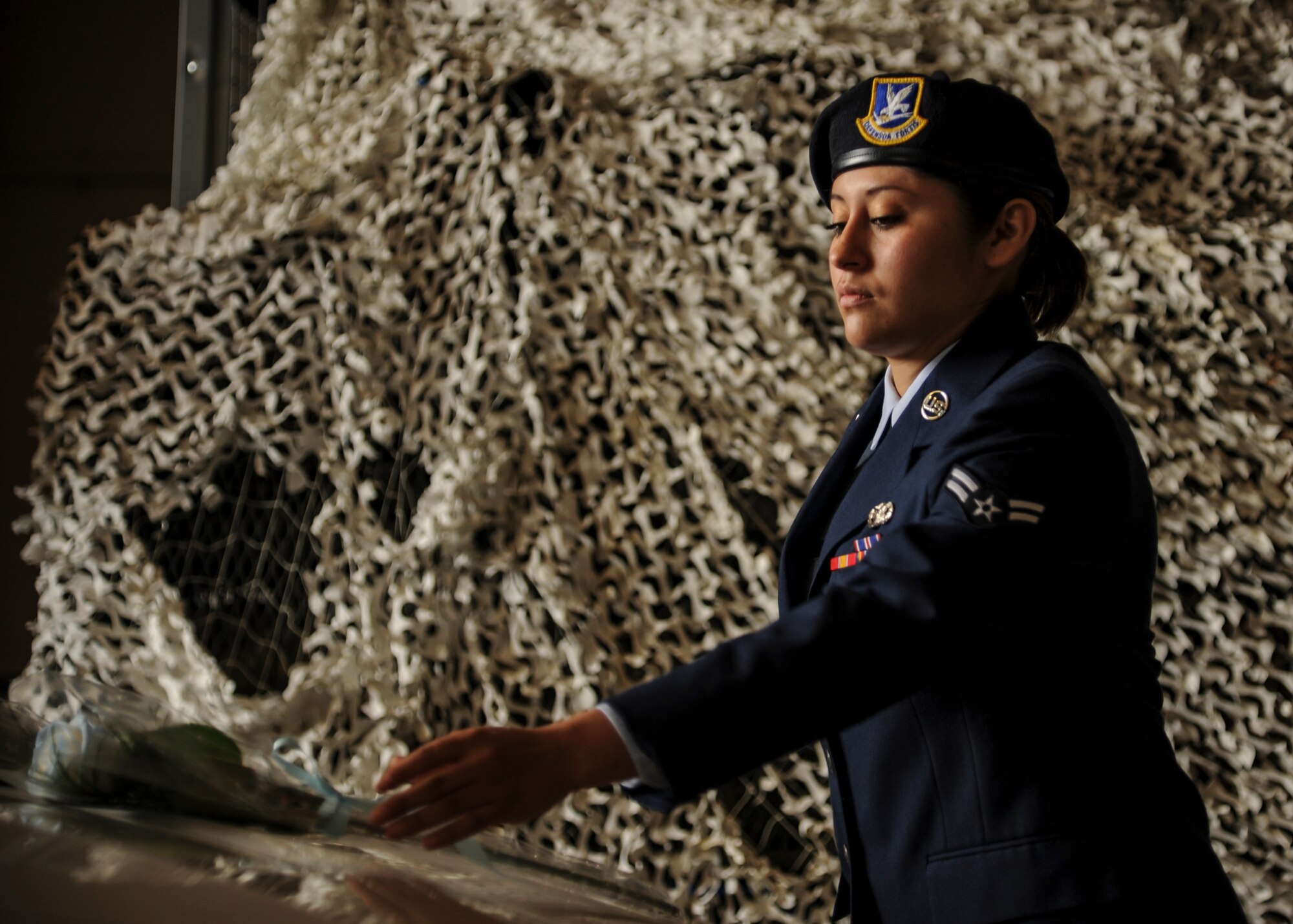 Airman 1st Class Viridiana Montes, 19th Security Forces Squadron patrolman, places a flower on the hood of a police vehicle as part of a memorial ceremony May 15, 2015, at Little Rock Air Force Base, Ark. The event commemorated fallen military and civilian law enforcement officers and concluded National Police Week at “The Rock”. (U.S. Air Force photo by Senior Airman Harry Brexel)