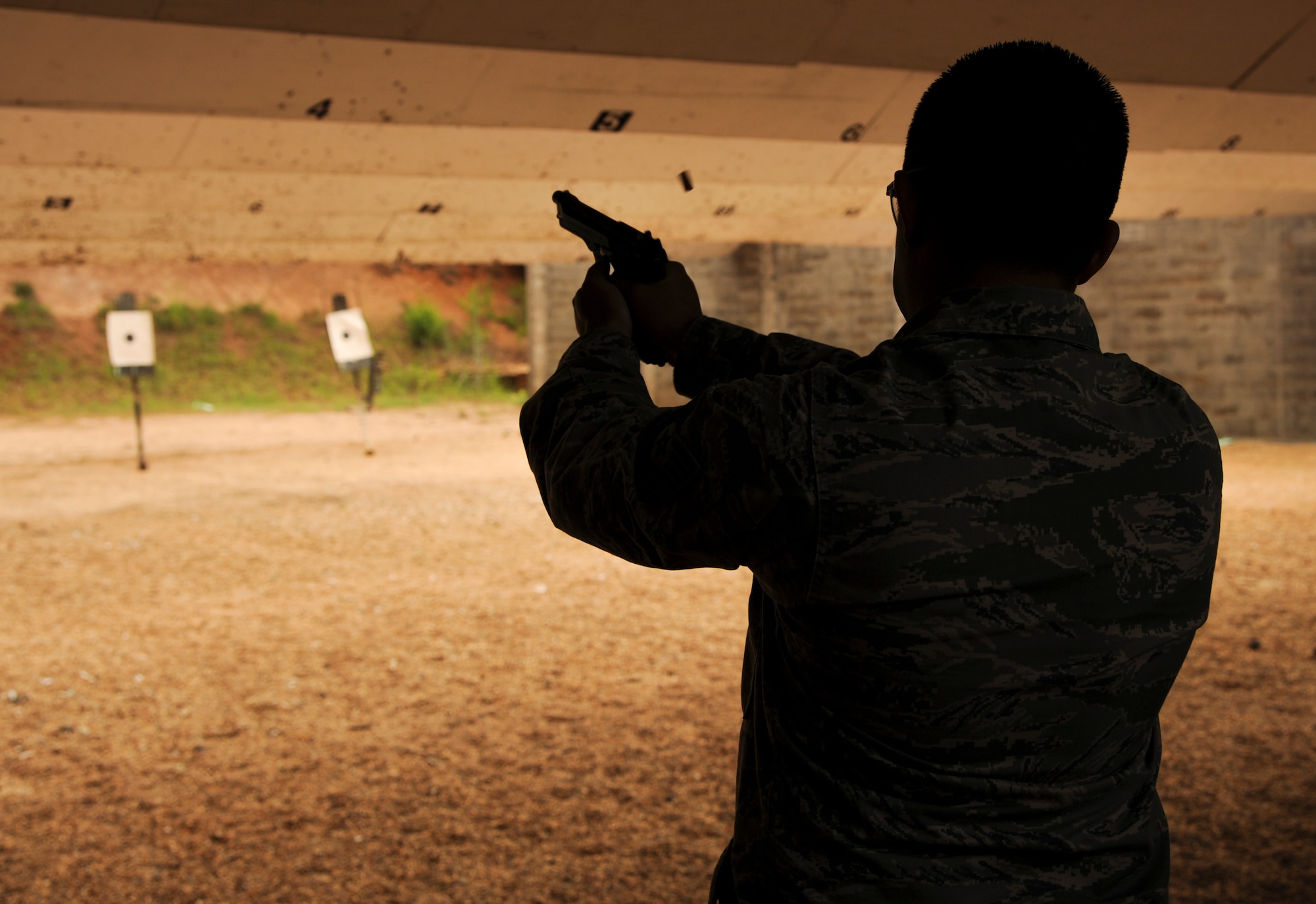 Tech. Sgt. Christopher Springs, 314th Aircraft Maintenance Squadron electrical environmental systems lead technician, fires a 9mm during a shooting competition May 13, 2015, at Little Rock Air Force Base, Ark. The competition was one of several events held by the 19th Security Forces Squadron in honor of National Police Week. (U.S. Air Force photo by Senior Airman Harry Brexel)