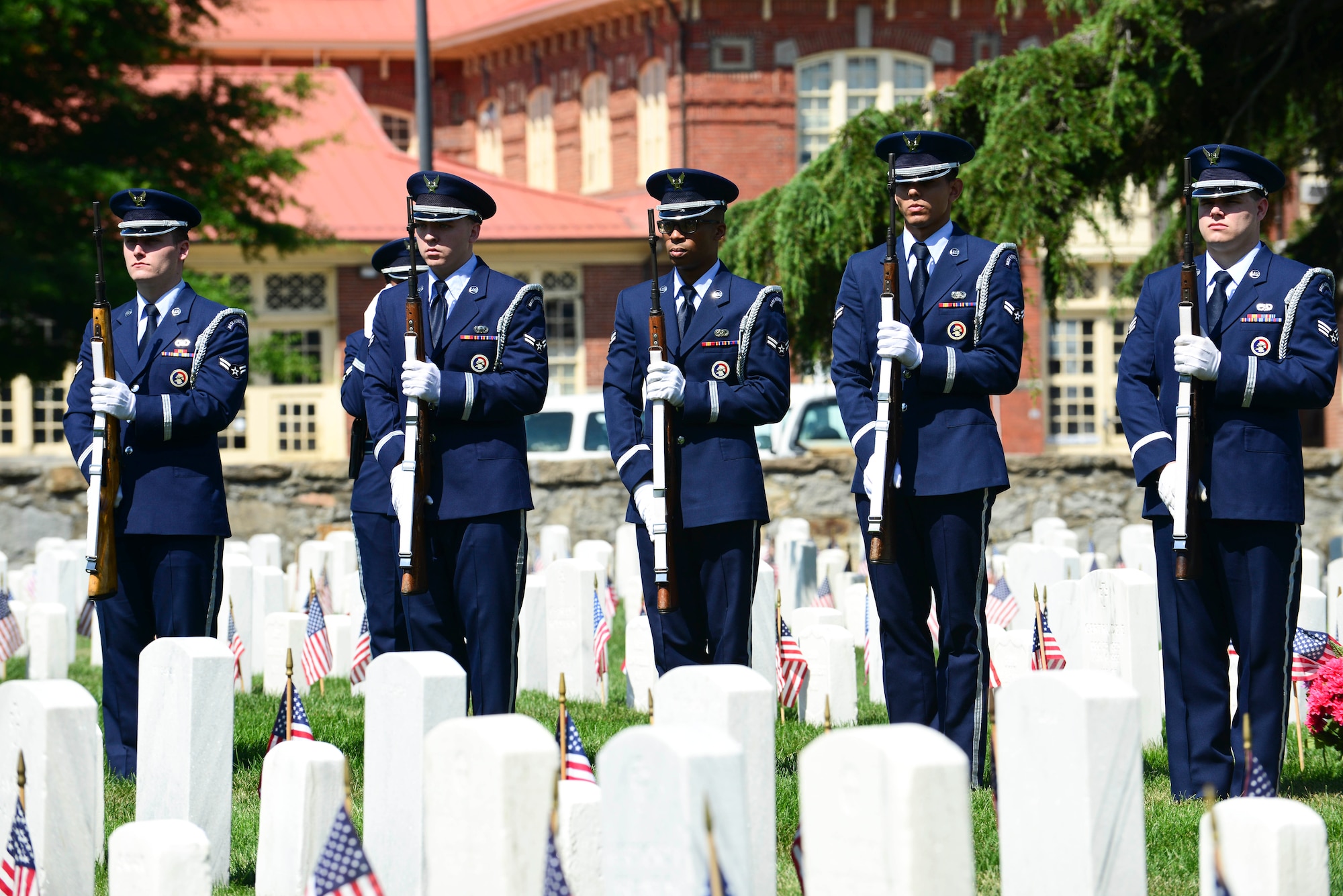 U.S. Air Force Airmen from the Langley Air Force Base Honor Guard stand at attention as Taps is played during a Memorial Day Ceremony in Hampton, Va., May 25, 2015. The honor guard, along with members of the crowd stood still and silent to honor all fallen Service members during the playing of the song. (U.S. Air Force photo by Senior Airman Kimberly Nagle/Released)  