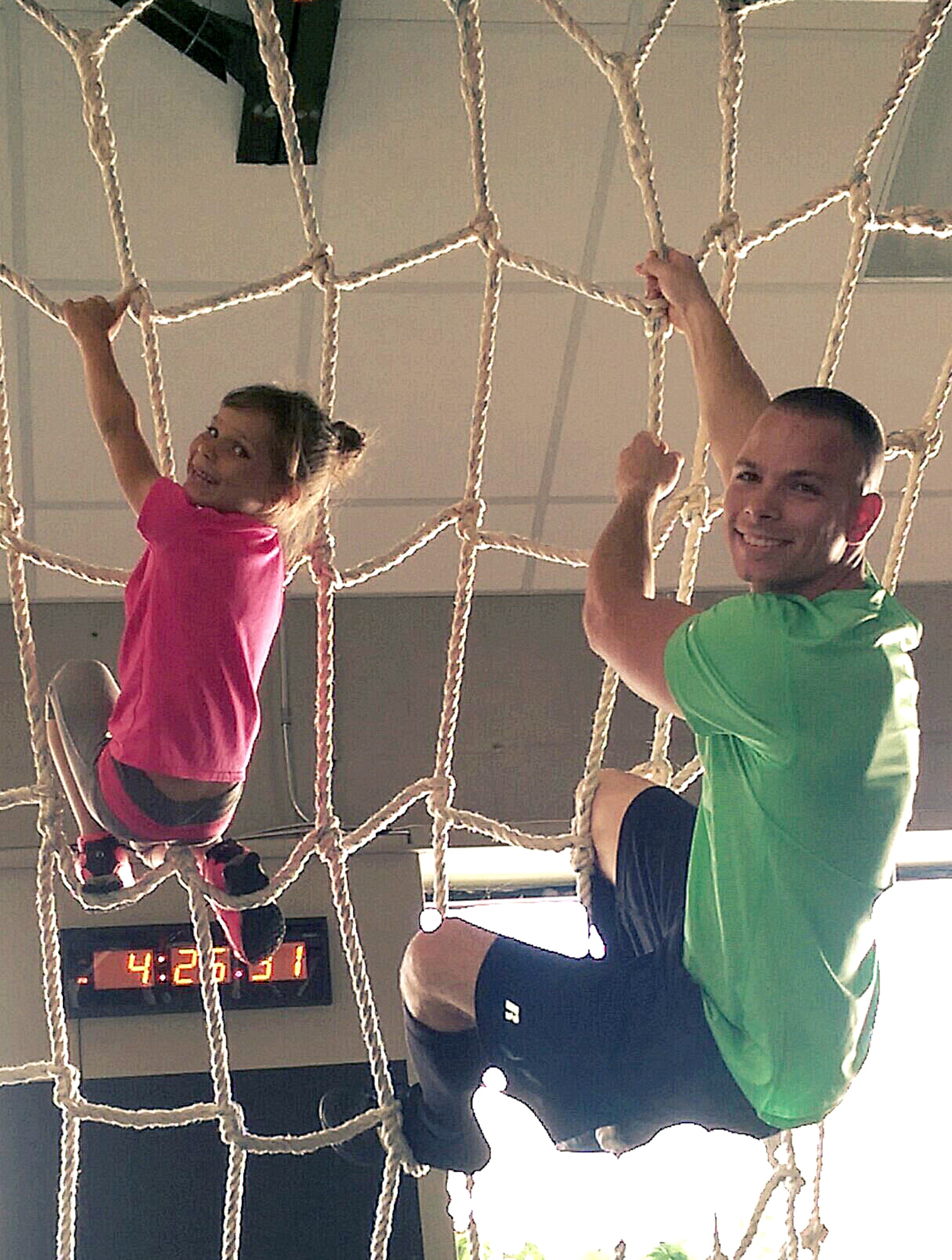 Staff Sgt. Randall Forsythe trains with his daughter to compete on the TV show American Ninja Warrior May 28,2015. Forsythe, 375th Civil Engineer Squadron firefighter, found out he was selected to participate on a special military tribute episode in April.. (Courtesy photo)
