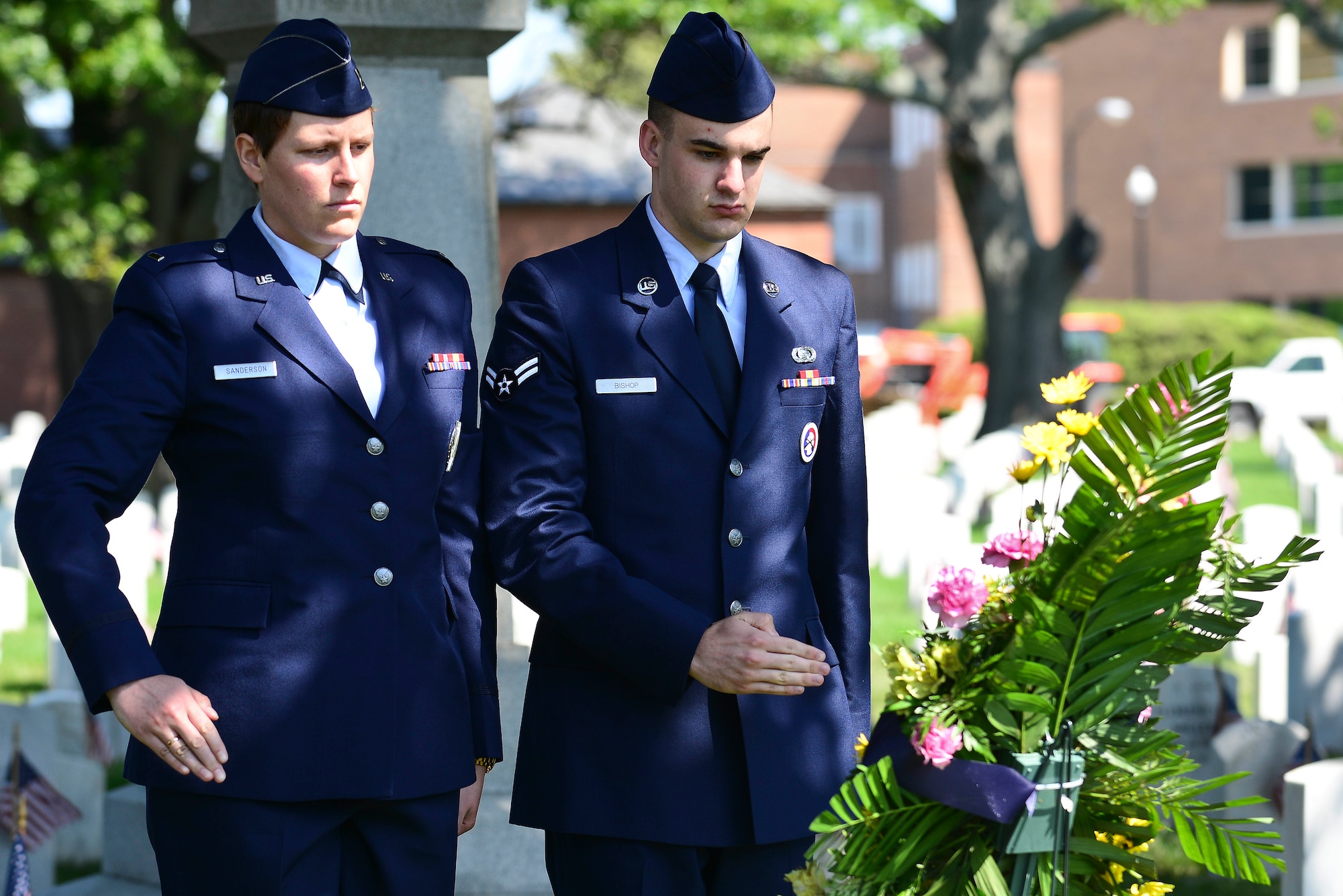 U.S. Air Force 1st Lt. Dawn Sanderson, left, and Airman First Class Michael Bishop salute during a Memorial Day Ceremony in Hampton, Va., May 25, 2015.  During the ceremony, Sanderson and Bishop placed a wreath on the gravesite of a fallen Service member and saluted to honor their service to the nation. (U.S. Air Force photo by Senior Airman Kimberly Nagle/Released)  