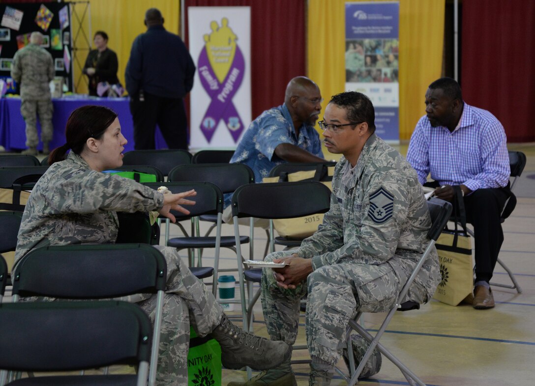 Senior Master Sgt. Johnson and Tech. Sgt. Loucas converse after sampling different ethnic foods at Unity Day May 21 at the 5th Regiment Armory in Baltimore. Unity Day has existed since 2006. (Photo by Airman 1st Class Enjoli M. Saunders/RELEASED)
