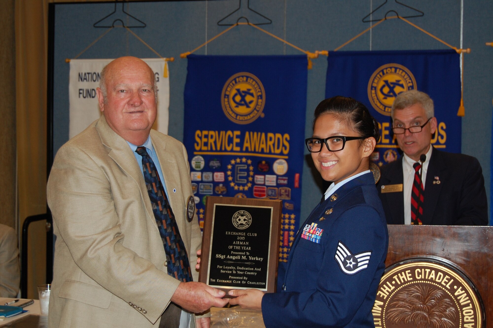 Staff Sgt. Angeli Yerkey, 437th Aerial Port Squadron, is presented the Exchange Club of Charleston’s Airman of the Year award by Don Gardner, a club member, during club’s Military Awards Luncheon May 14, 2015 at the Citadel Alumni Center in Charleston, S.C.  The Exchange Club of Charleston hosts the luncheon each year and uses it as a way to recognize local service members for their “selfless commitment and dedication.” As a member of the 437th APS, Yerkey has managed security clearances for more than 400 Airmen and civilians as well as routinely validating the squadron’s security program by testing reactions and compliance, which corrected security vulnerability and boosted the overall security of 12 facilities valued at $23.4 million. She has also volunteered more than 100 hours of service as the Squadron Booster Club vice president, the Asian-American Committee lead as well as serving as a 2015 Air Force Ball committee member. Lastly, Yerkey continues to further her education and has completed 33 course hours toward a Bachelor’s Degree in Management and Human Resources. (Courtesy photo / Exchange Club of Charleston)  

