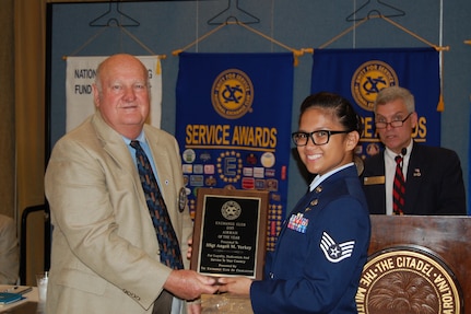 Staff Sgt. Angeli Yerkey, 437th Aerial Port Squadron, is presented the Exchange Club of Charleston’s Airman of the Year award by Don Gardner, a club member, during club’s Military Awards Luncheon May 14, 2015 at the Citadel Alumni Center in Charleston, S.C.  The Exchange Club of Charleston hosts the luncheon each year and uses it as a way to recognize local service members for their “selfless commitment and dedication.” As a member of the 437th APS, Yerkey has managed security clearances for more than 400 Airmen and civilians as well as routinely validating the squadron’s security program by testing reactions and compliance, which corrected security vulnerability and boosted the overall security of 12 facilities valued at $23.4 million. She has also volunteered more than 100 hours of service as the Squadron Booster Club vice president, the Asian-American Committee lead as well as serving as a 2015 Air Force Ball committee member. Lastly, Yerkey continues to further her education and has completed 33 course hours toward a Bachelor’s Degree in Management and Human Resources. (Courtesy photo / Exchange Club of Charleston)  

