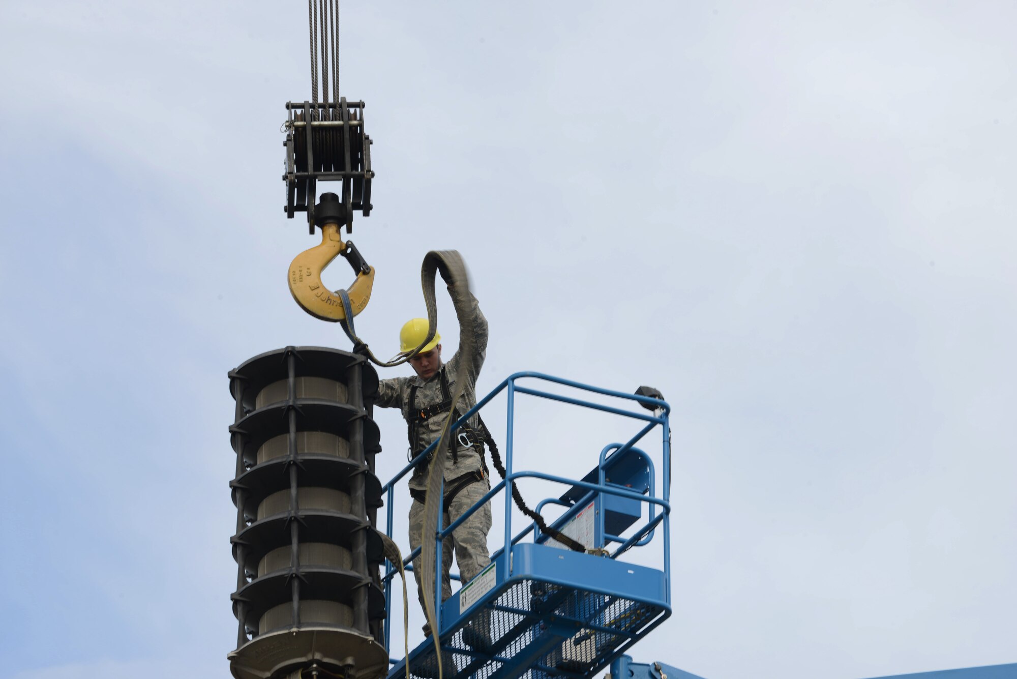 U.S. Air Force Airman 1st Class Devan Stutler, a 354th Communications Squadron radio frequency transmission systems apprentice, secures lifting straps on an outdated Giant Voice system speaker cell May 15, 2015, at Eielson Air Force Base, Alaska. The older system was installed in 2003 and aged quickly due to the area’s harsh winters. (U.S. Air Force photo by Senior Airman Ashley Nicole Taylor/Released)
