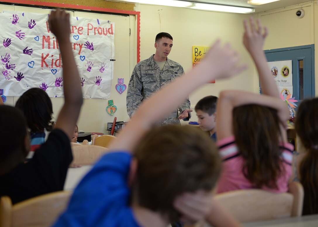 U.S. Air Force Tech. Sgt. Jimmy Boulware, a 354th Logistics Readiness Squadron quality assurance inspector, answers questions at the school age program May 27, 2015, at Eielson Air Force Base, Alaska, about being injured in an improvised explosive device blast while deployed in 2005. Boulware shared his story with the students to help them understand the significance and history of the Purple Heart. (U.S. Air Force photo by Staff Sgt. Shawn Nickel/Released)