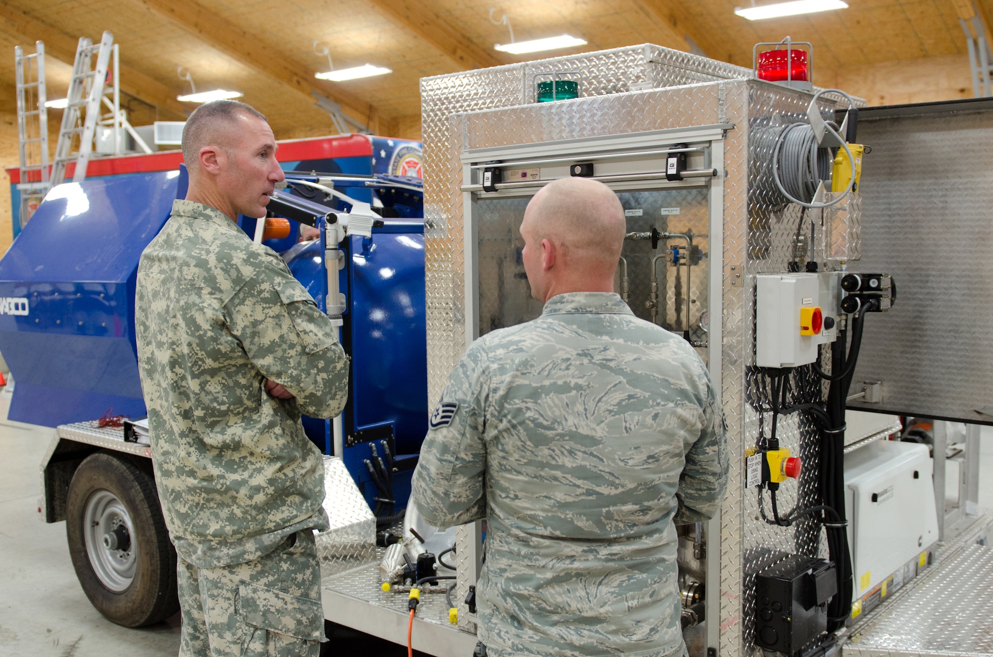 Staff Sgt. Timothy Baker (right), an Explosive Ordinance Disposal technician for the Kentucky Air National Guard's 123rd Civil Engineer Squadron, explains the capabilities of the unit's new Bomb Containment Vessel to Army Col. Brian Wertzler, the Kentucky National Guard's United States Property and Fiscal Office officer, during training at the Fern Creek Fire Department in Louisville, Ky., Nov. 11, 2014. The steel vessel, which is mounted to a trailer, allows EOD personnel to detonate explosives on-site with no repercussions to nearby people or structures. (U.S. Air National Guard photo by Master Sgt. Phil Speck)
