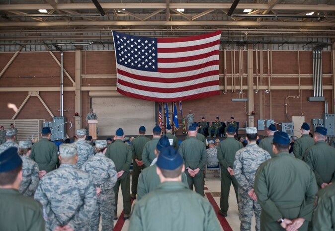 Airmen stand in formation during the opening remarks of the U.S. Air Force Weapons School’s change of command ceremony at Nellis Air Force Base, Nev., May 26, 2015. During the ceremony, command of the USAFWS passed from Col. Adrian Spain to Col. Michael Drowley. (U.S. Air Force photo by Staff Sgt. Siuta B. Ika)