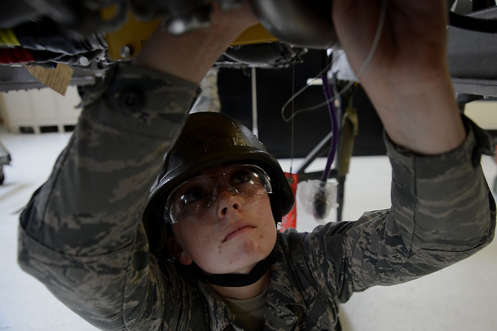 A U.S. Air Force Airman assigned to the 20th Component Maintenance Squadron propulsion flight tightens a bolt on an F-16CM Fighting Falcon engine during the operational readiness exercise Weasel Victory 15-06 at Shaw Air Force Base, S.C., May 27, 2015. The ORE is part of annual training and inspections of the 20th Fighter Wings combat readiness. (U.S. Air Force photo by Airman 1st Class Michael Cossaboom/Released)