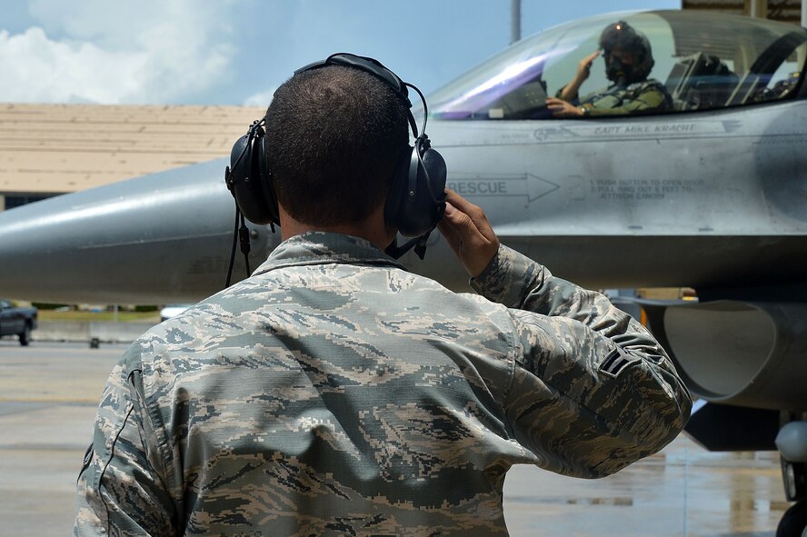 A U.S. Air Force Airman assigned to the 20th Maintenance Group salutes an F-16CM Fighting Falcon during the operational readiness exercise Weasel Victory 15-06 at Shaw Air Force Base, S.C., May 27, 2015. Several F-16s flew sorties during the exercise demonstrating the ability of 20th Fighter Wing personnel to effectively generate and employ aircraft at a moment’s notice. (U.S. Air Force photo by Airman 1st Class Michael Cossaboom/Released)