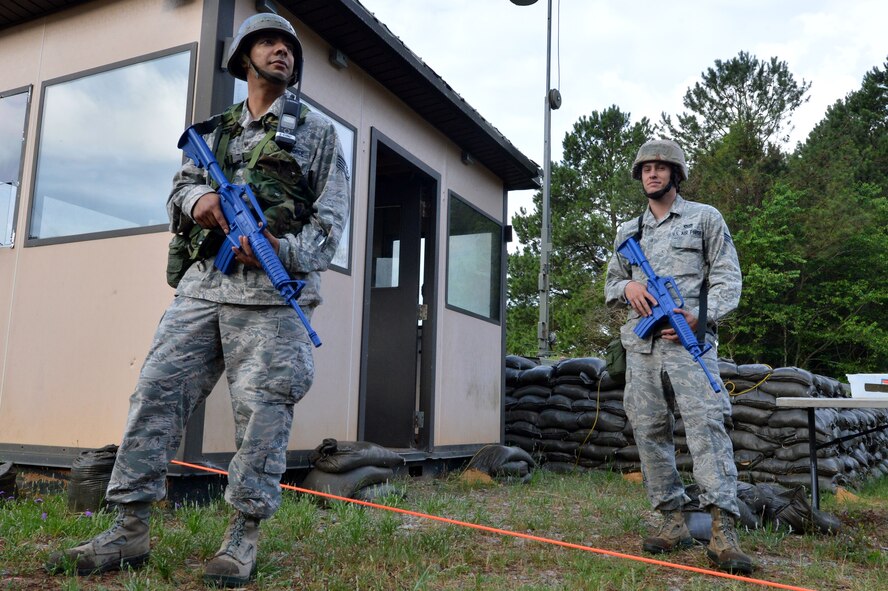 U.S. Air Force Staff Sgt. William Gautran, 20th Civil Engineer Squadron electrical systems craftsman, and Senior Airman Justin Fleming, 20th CES electrical systems technician, stand guard at “Base X” during operational readiness exercise Weasel Victory 15-06 at Shaw Air Force Base, S.C., May 27, 2015. An ORE tests the combat readiness and capabilities of Airmen through a variety of simulated events. (U.S. Air Force photo by Airman 1st Class Michael Cossaboom/Released) 