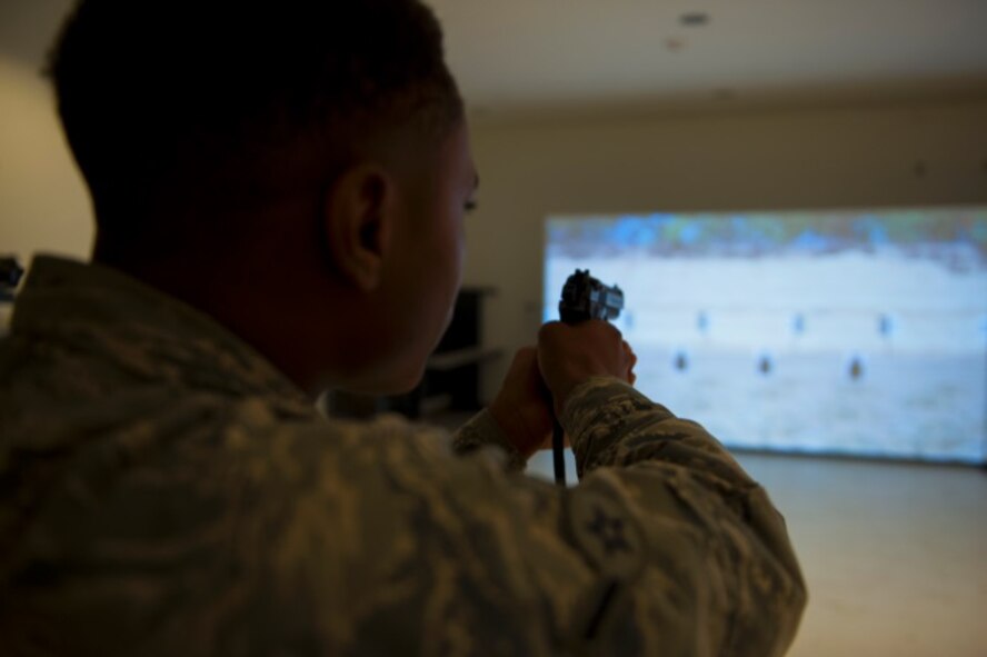 A Minot Airman aims a Beretta M-9 during a pistol shoot-off on Minot Air Force Base, N.D., May 20, 2015. Prizes were handed out to the first, second and third place winners. (U.S. Air Force photo/Airman 1st Class Christian Sullivan)