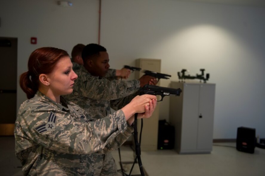 Minot Airmen shoot a Beretta M-9 pistol at a virtual reality shooting range on Minot Air Force Base, N.D., May 20, 2015. Prizes were handed out to the first, second and third place winners. (U.S. Air Force photo/Airman 1st Class Christian Sullivan)