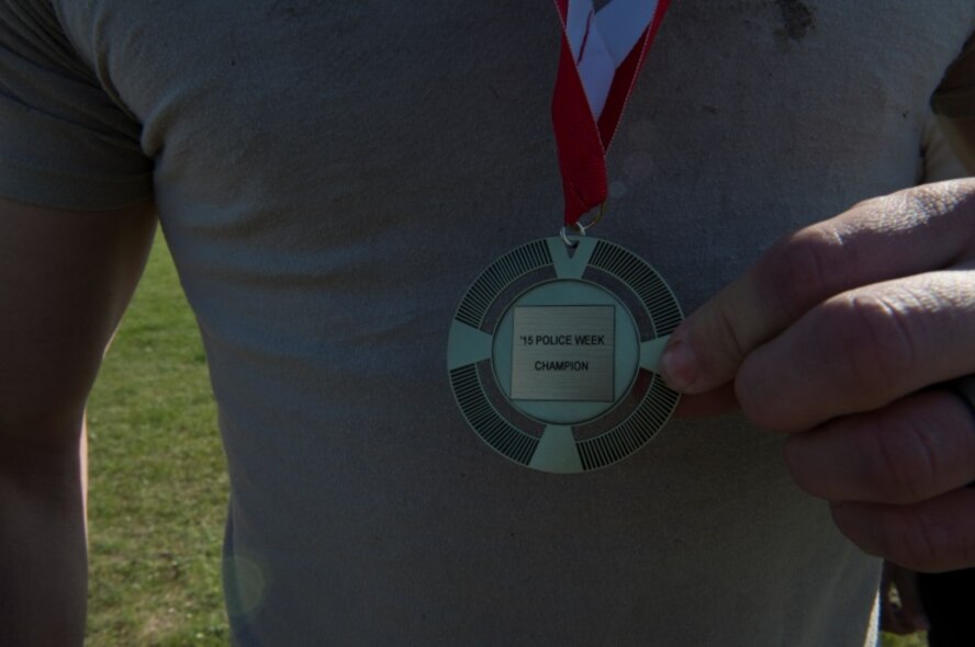 An Airman from the 5th Security Forces Squadron Bravo Flight holds his first place medal after winning the Security Forces Survivors Challenge on Minot Air Force Base, N.D., May 20, 2015. The Security Forces Survivors Challenge was an event held for Police Week, which honors fallen police officers in the line of duty. (U.S. Air Force photo/Airman 1st Class Christian Sullivan)
